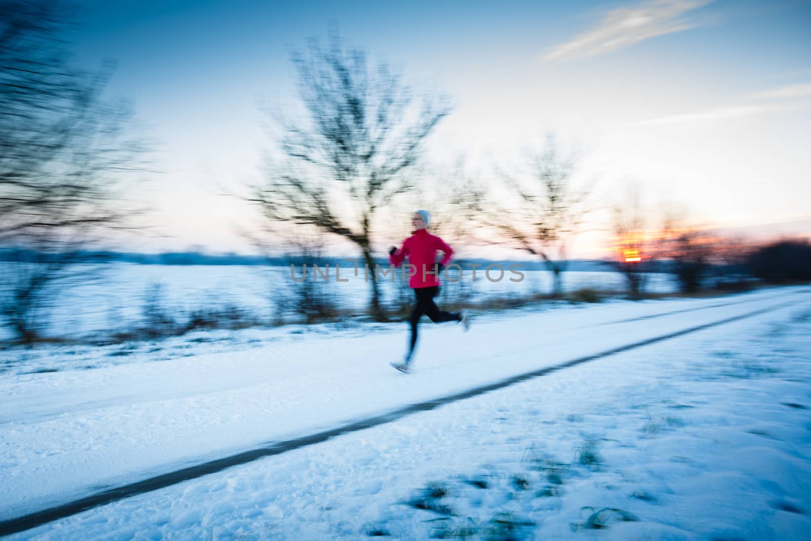 Winter running - Young woman running outdoors by viktor_cap