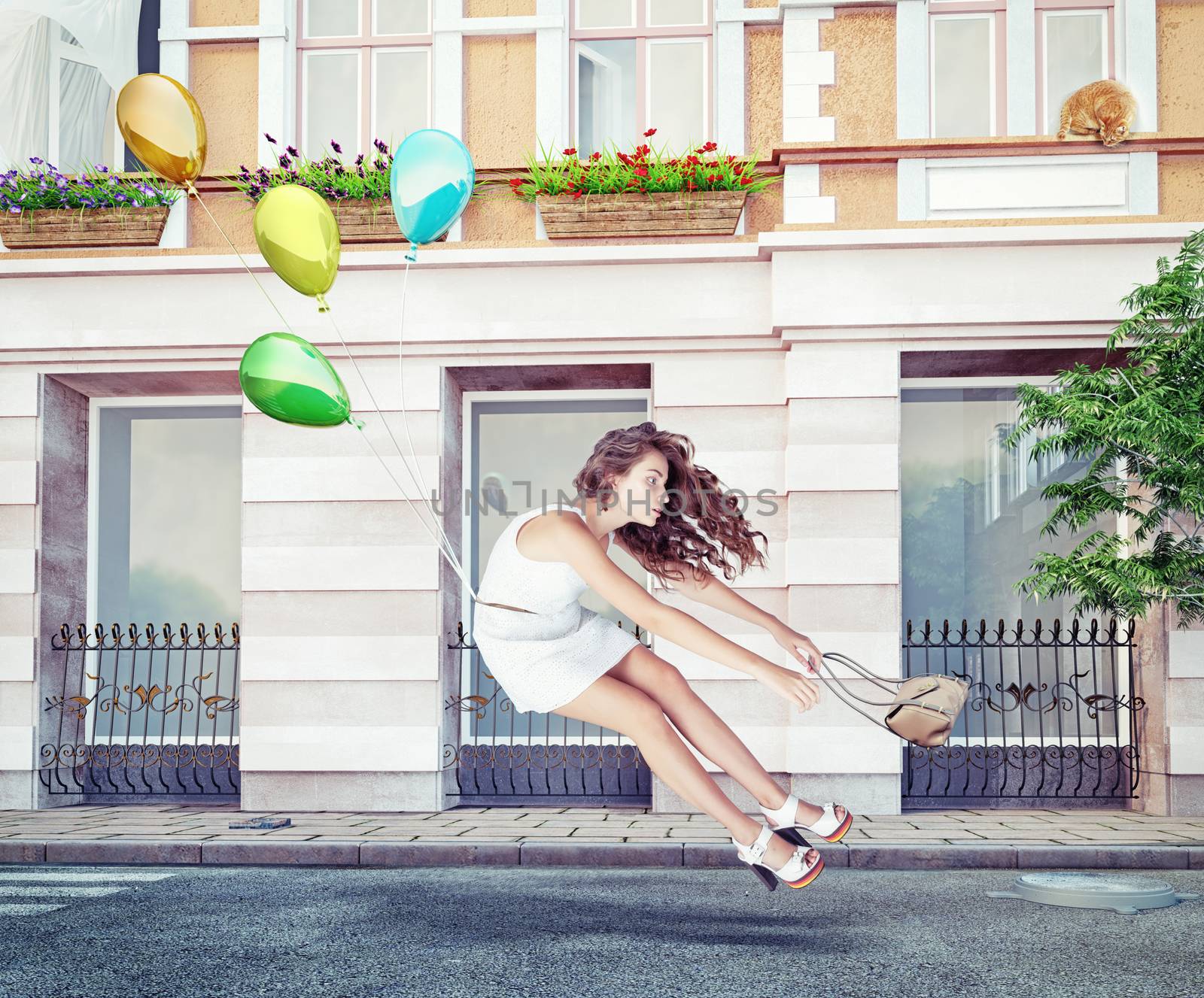 Balloons fly with young beautiful girl. Creative concept