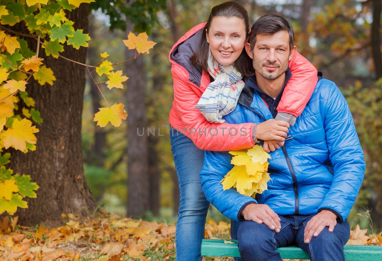 Couple on a bench in the autumn park