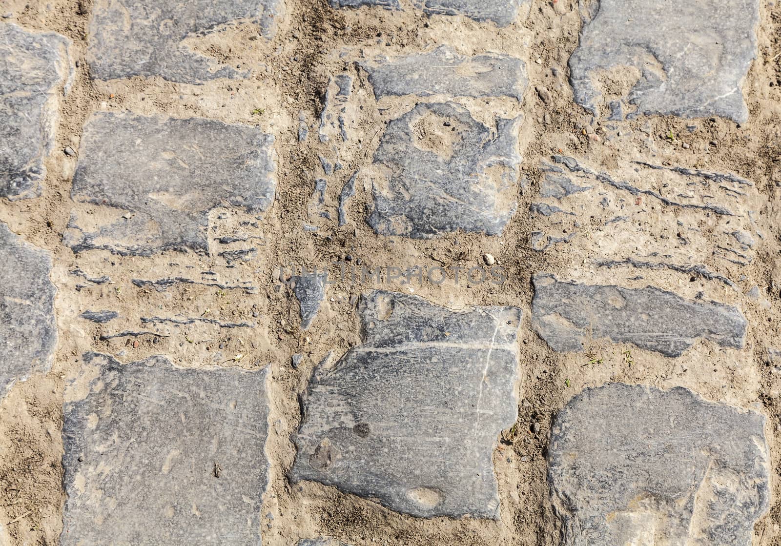 Detail of a cobbelstone road located in the North of France near Lille. On such roads every year is organized one of the most famous one day cycling race Paris-Roubaix.