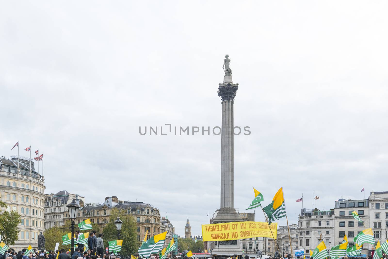 LONDON, UK - OCTOBER 26: Protesters wave Kashmiri flags in Trafalgar Square. The protest, named the Million March, denounced the human rights violation by India in Kashmir. October 26, 2014 in London.