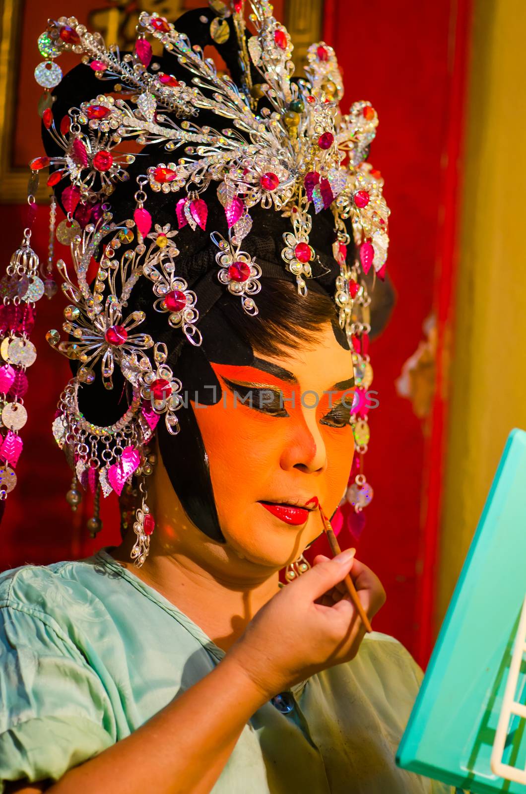 BANGKOK - OCTOBER 22: Unidentified Chinese opera actress applies makeup backstage at Theaters of Thailand's ethnic Chinese in Chinatown on October 27, 2014 in Bangkok, Thailand.