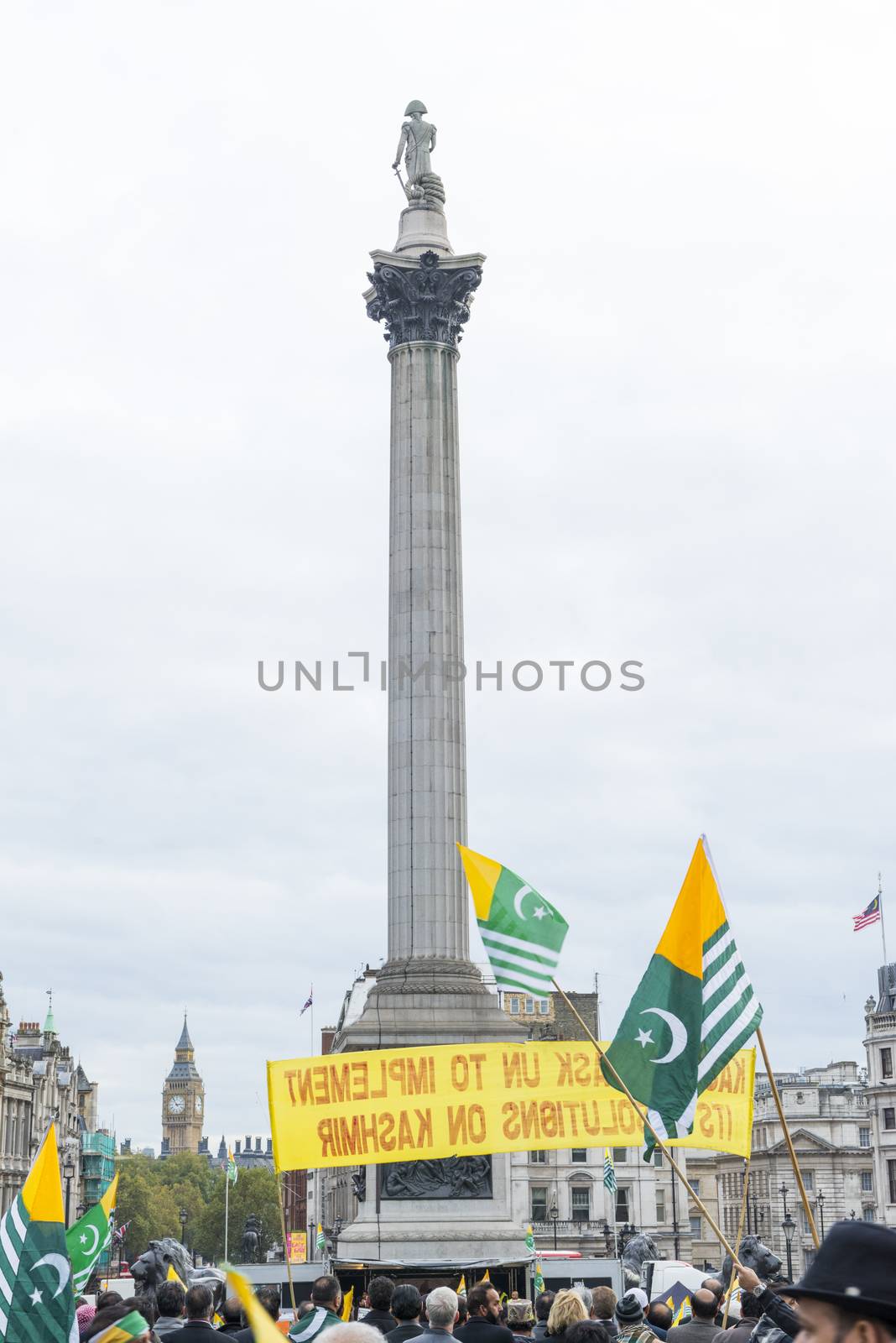 LONDON, UK - OCTOBER 26: Protesters wave Kashmiri flags in Trafalgar Square. The protest, named the Million March, denounced the human rights violation by India in Kashmir. October 26, 2014 in London.