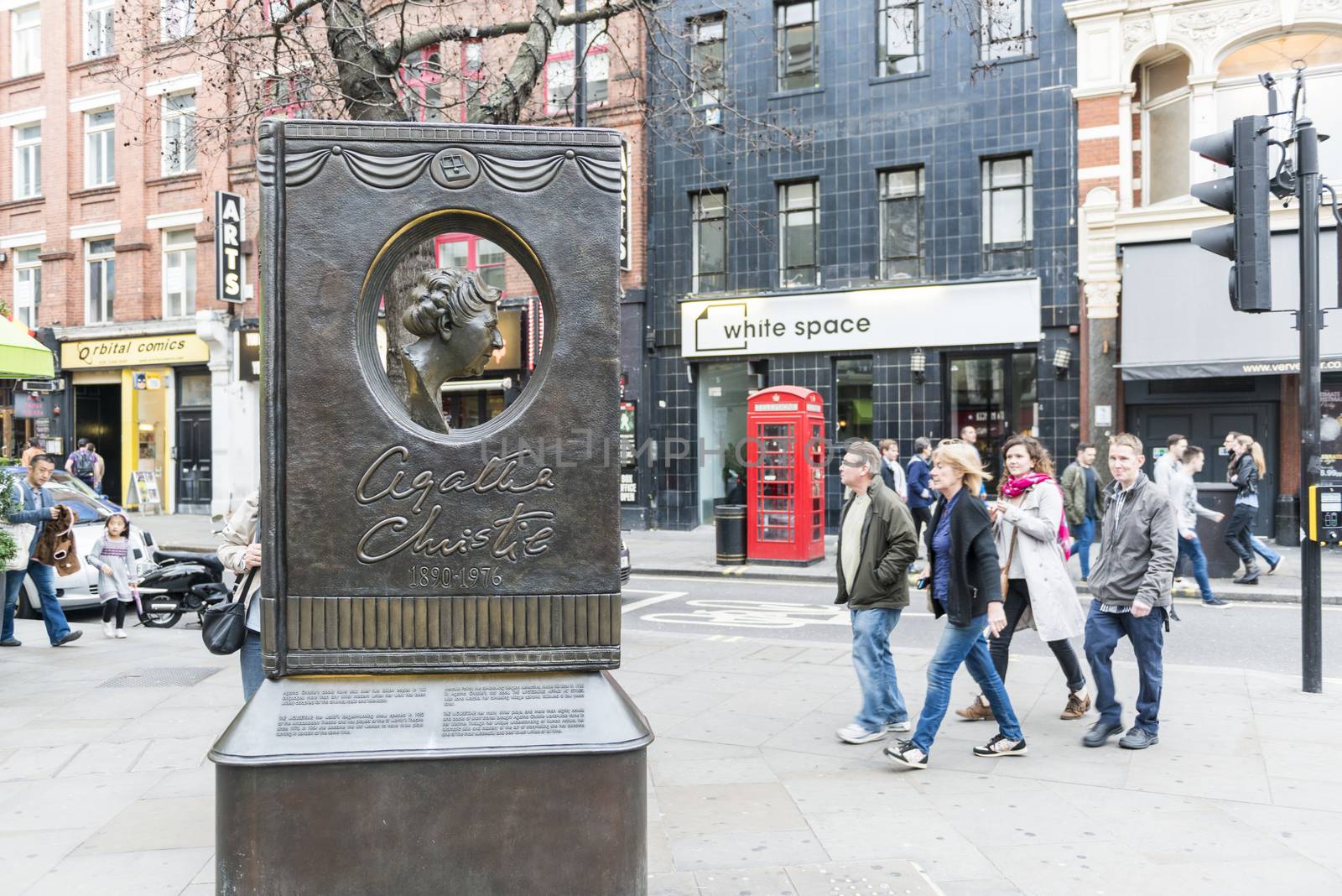 LONDON, UK - OCTOBER 26: Agatha Christie book shaped memorial with busy street in the background. The bronze memorial was unveiled on the 18 November 2012. October 26, 2014 in London.