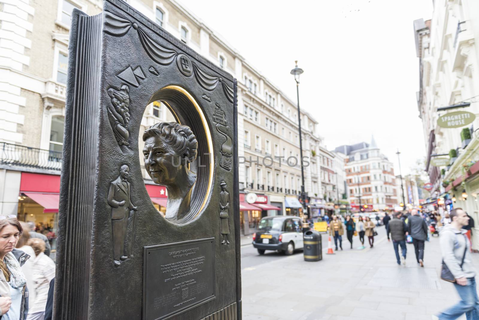 LONDON, UK - OCTOBER 26: Agatha Christie book shaped memorial with busy street in the background. The bronze memorial was unveiled on the 18 November 2012. October 26, 2014 in London.
