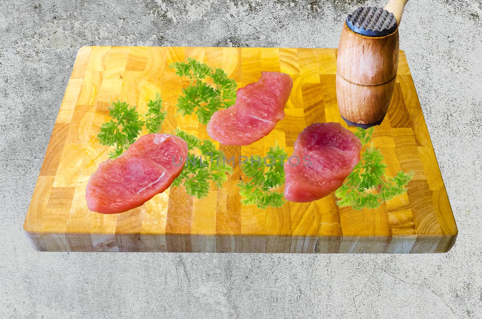 Three cutlet on a wooden board with parsley be knocked flat.
