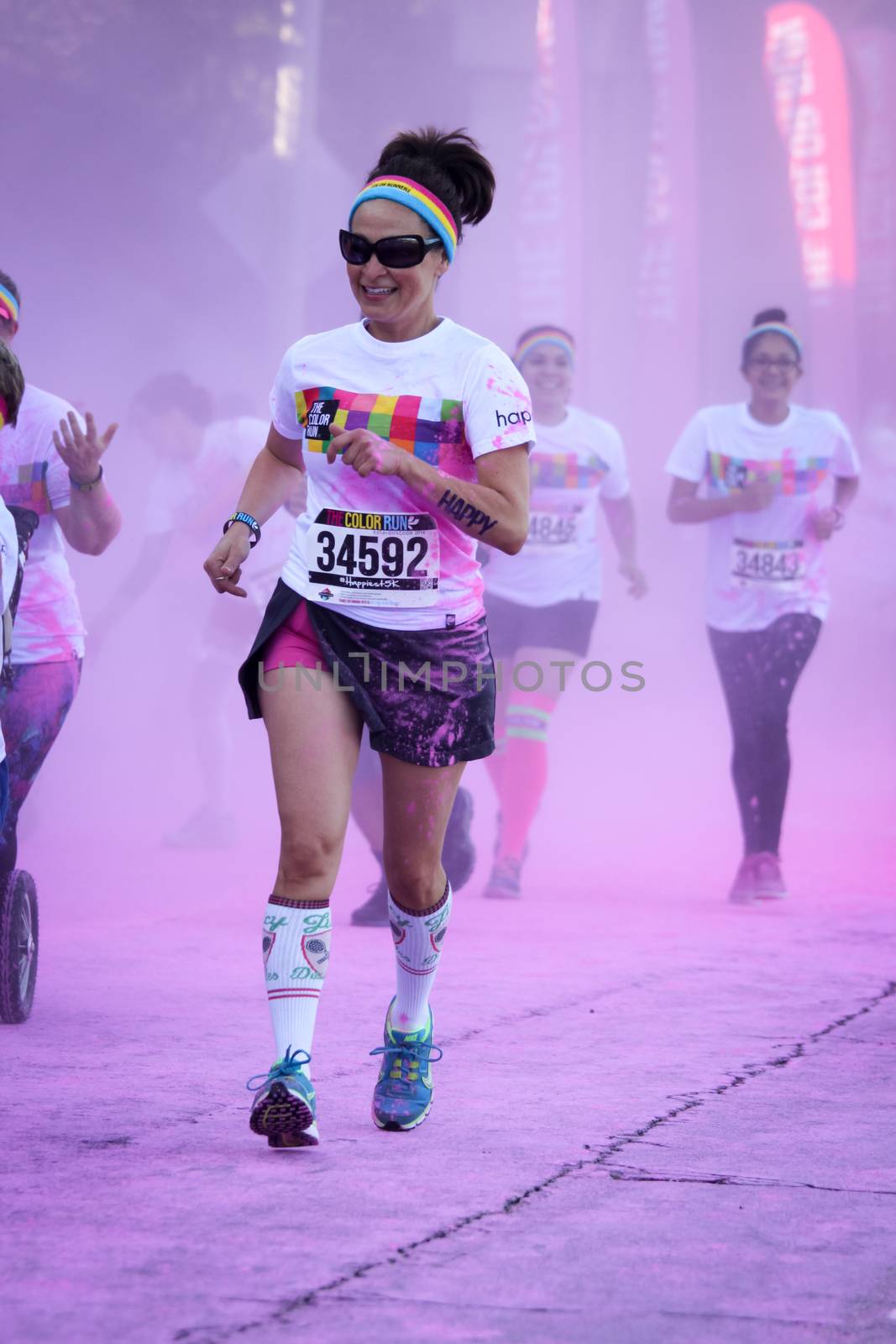 Ventura, CA - OCTOBER 18 : Participants coming through the pink color station at The Color Run 2014 in Ventura. OCTOBER 18, 2014 in Ventura, CA.