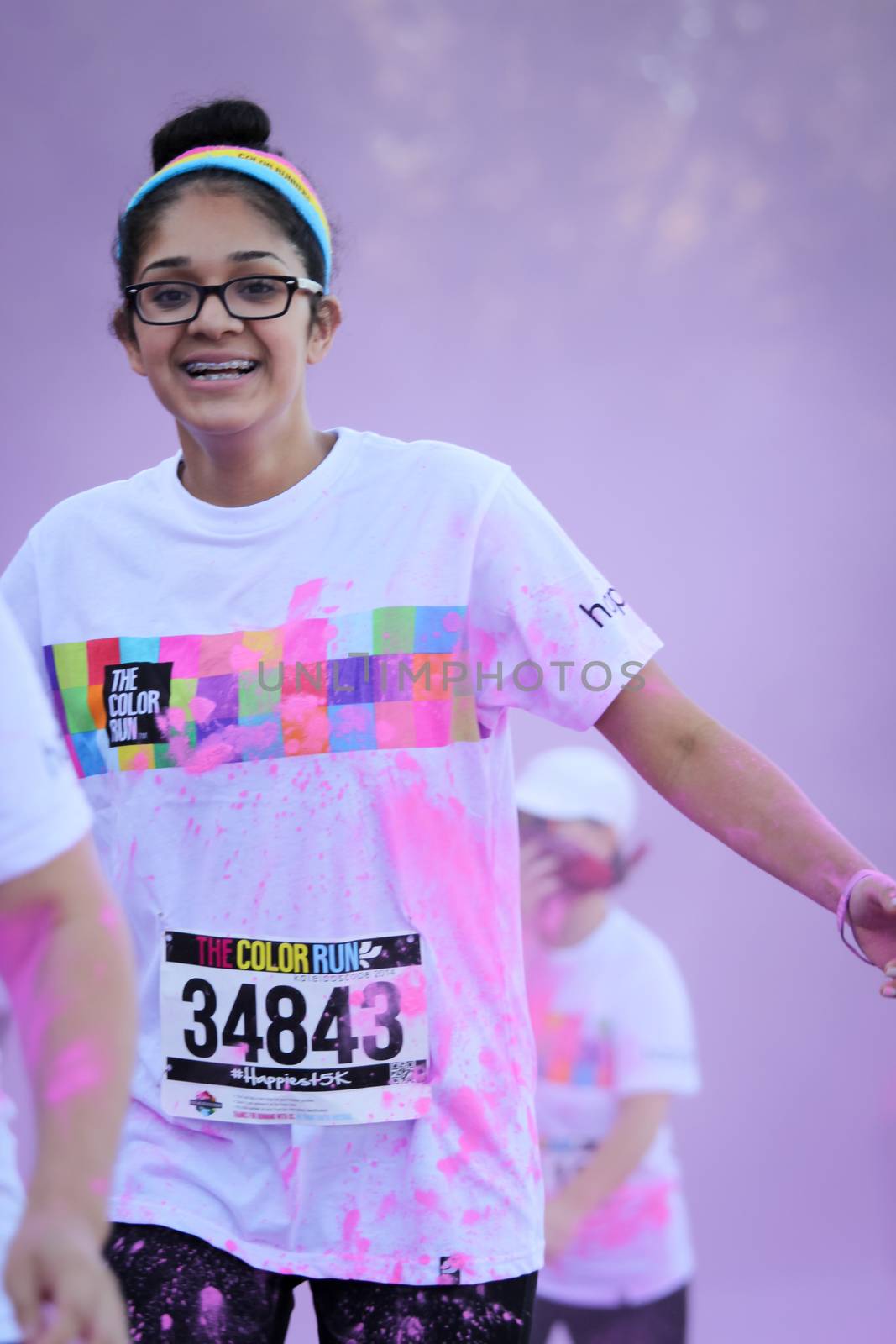 Ventura, CA - OCTOBER 18 : Participants coming through the pink color station at The Color Run 2014 in Ventura. OCTOBER 18, 2014 in Ventura, CA.