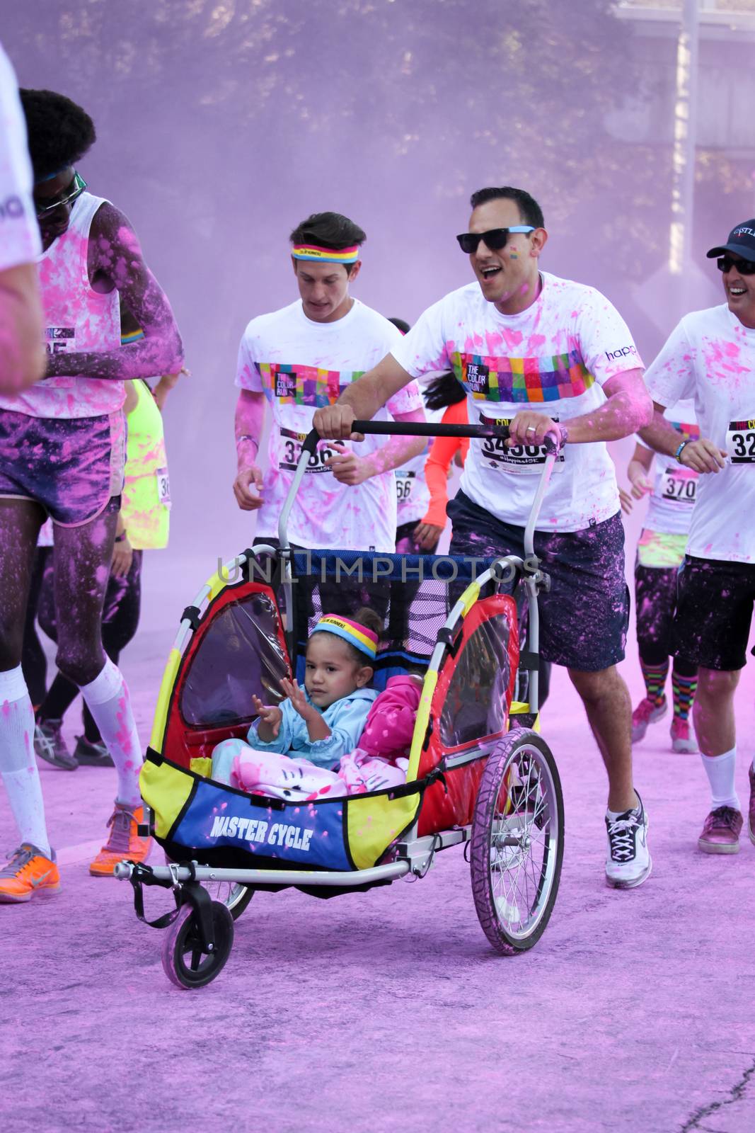 Ventura, CA - OCTOBER 18 : Participants coming through the pink color station at The Color Run 2014 in Ventura. OCTOBER 18, 2014 in Ventura, CA.