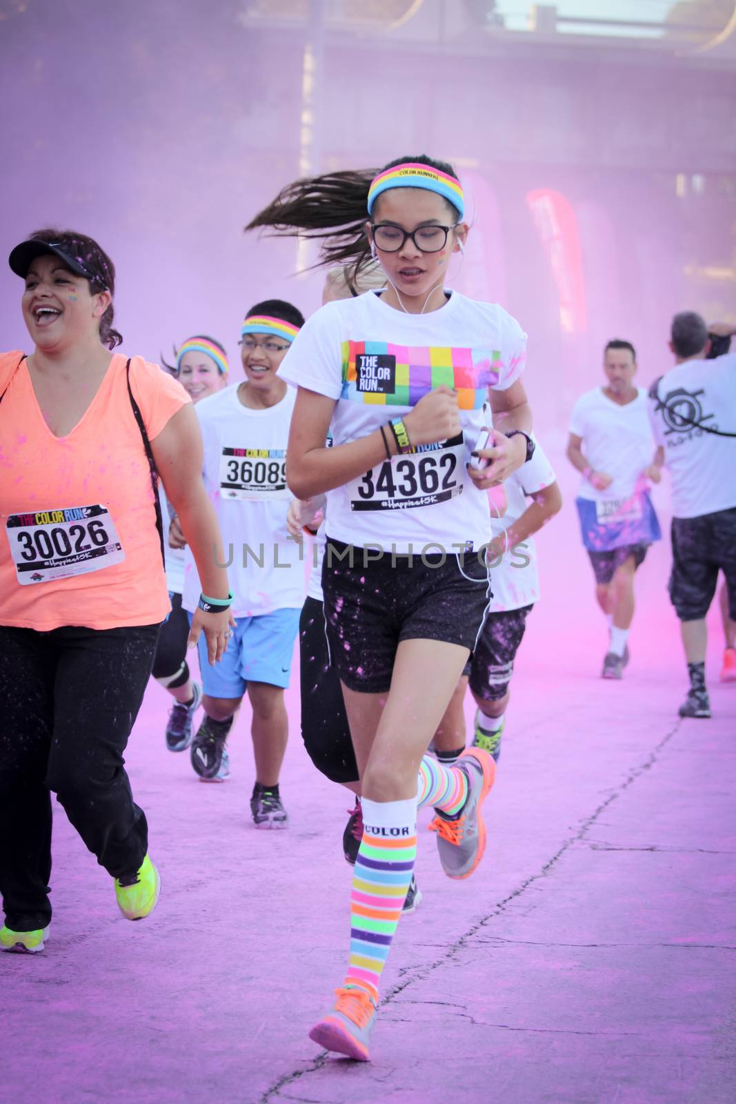 Ventura, CA - OCTOBER 18 : Participants coming through the pink color station at The Color Run 2014 in Ventura. OCTOBER 18, 2014 in Ventura, CA.