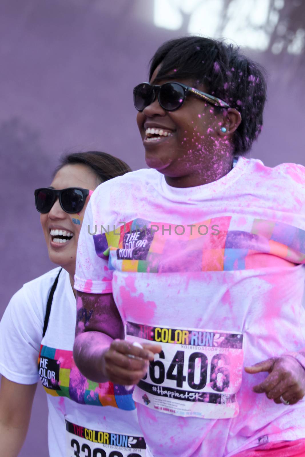 Ventura, CA - OCTOBER 18 : Participants coming through the pink color station at The Color Run 2014 in Ventura. OCTOBER 18, 2014 in Ventura, CA.