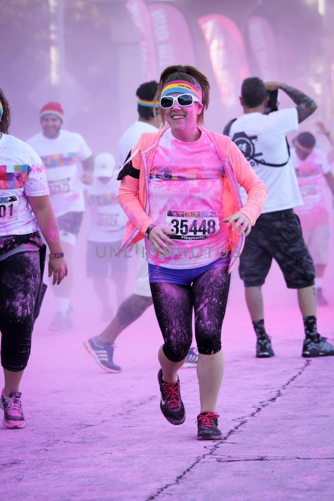 Ventura, CA - OCTOBER 18 : Participants coming through the pink color station at The Color Run 2014 in Ventura. OCTOBER 18, 2014 in Ventura, CA.