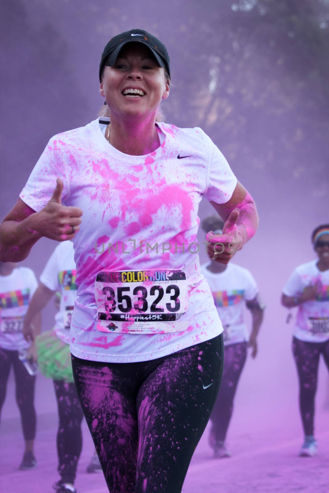 Ventura, CA - OCTOBER 18 : Participants coming through the pink color station at The Color Run 2014 in Ventura. OCTOBER 18, 2014 in Ventura, CA.