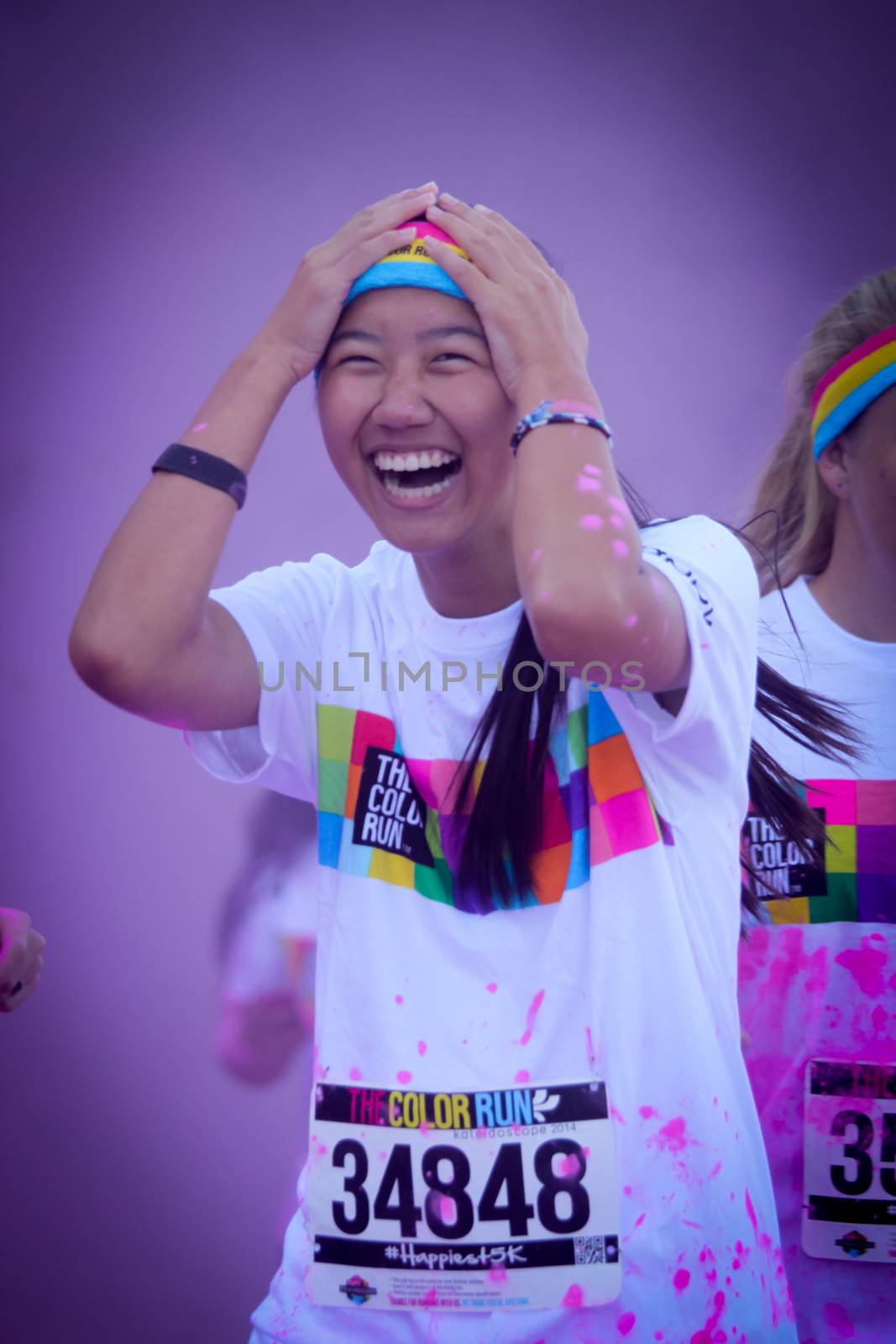 Ventura, CA - OCTOBER 18 : Participants coming through the pink color station at The Color Run 2014 in Ventura. OCTOBER 18, 2014 in Ventura, CA.