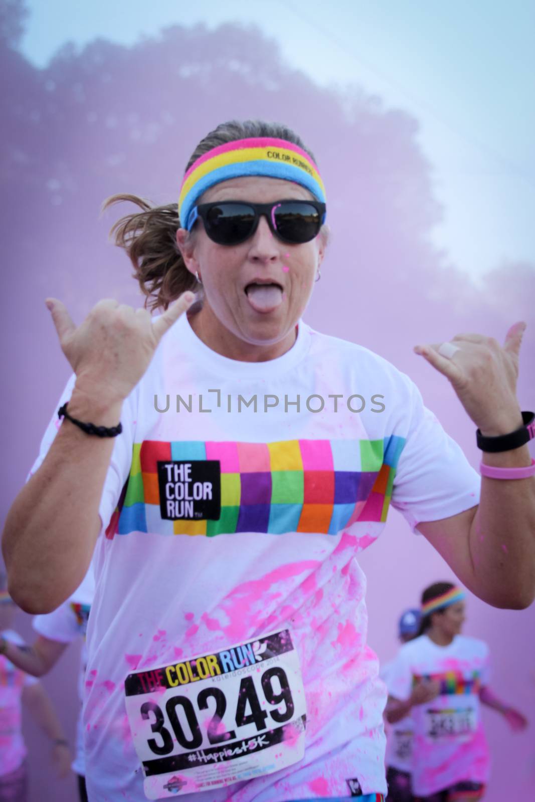 Ventura, CA - OCTOBER 18 : Participants coming through the pink color station at The Color Run 2014 in Ventura. OCTOBER 18, 2014 in Ventura, CA.