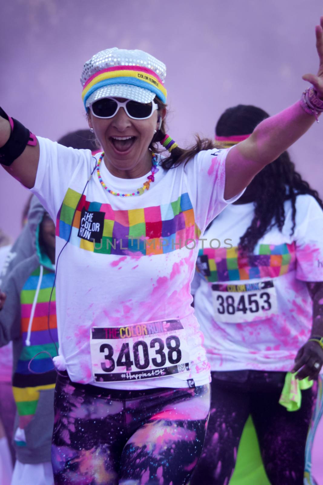 Ventura, CA - OCTOBER 18 : Participants coming through the pink color station at The Color Run 2014 in Ventura. OCTOBER 18, 2014 in Ventura, CA.