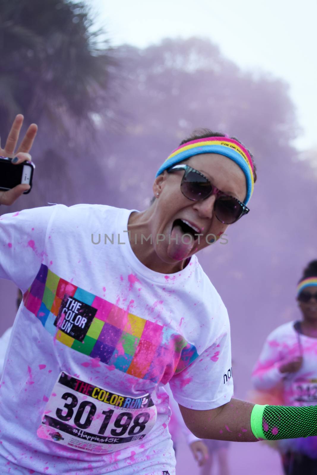 Ventura, CA - OCTOBER 18 : Participants coming through the pink color station at The Color Run 2014 in Ventura. OCTOBER 18, 2014 in Ventura, CA.