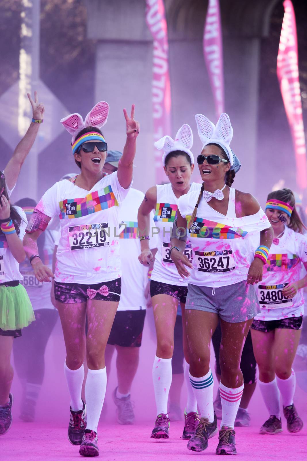 Ventura, CA - OCTOBER 18 : Participants coming through the pink color station at The Color Run 2014 in Ventura. OCTOBER 18, 2014 in Ventura, CA.