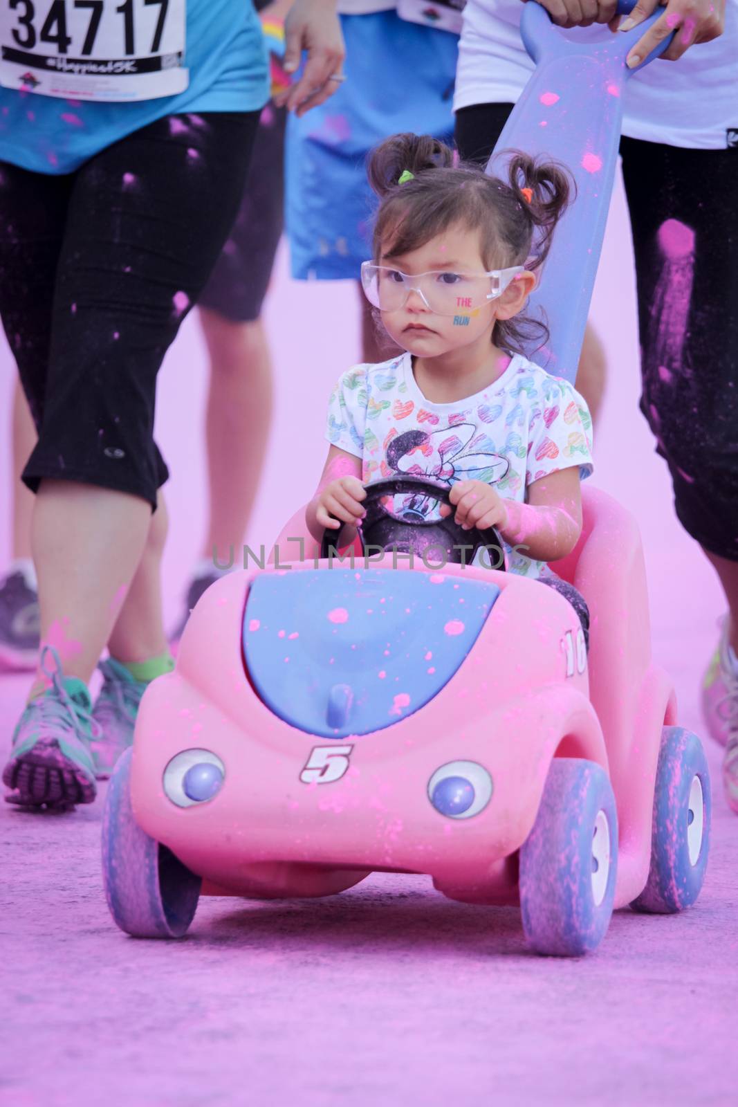 Ventura, CA - OCTOBER 18 : Participants coming through the pink color station at The Color Run 2014 in Ventura. OCTOBER 18, 2014 in Ventura, CA.