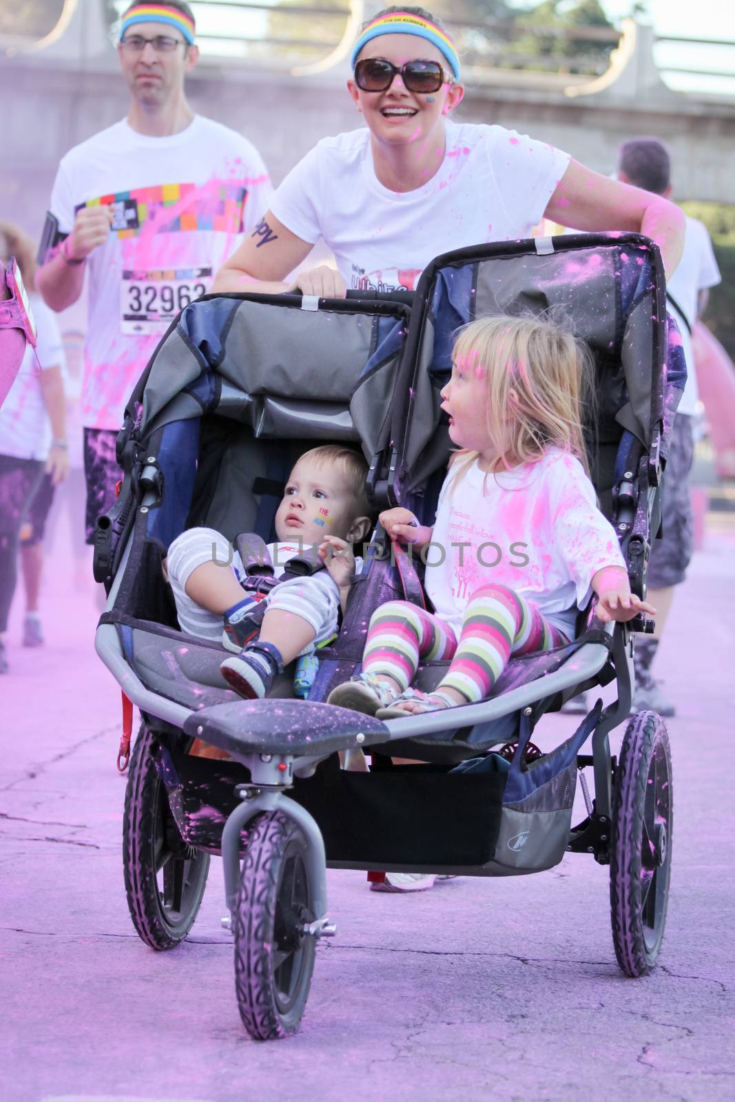 Ventura, CA - OCTOBER 18 : Participants coming through the pink color station at The Color Run 2014 in Ventura. OCTOBER 18, 2014 in Ventura, CA.