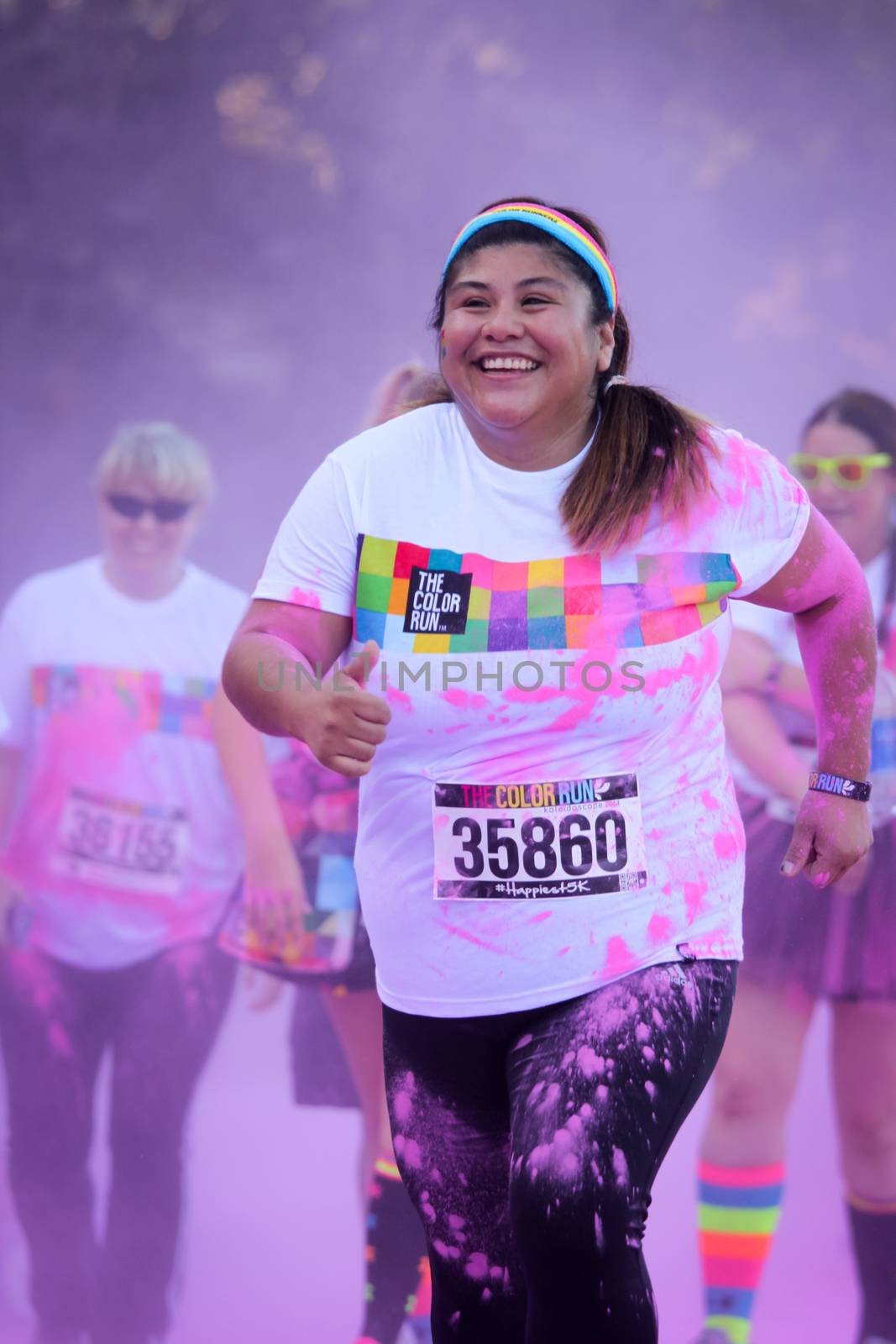 Ventura, CA - OCTOBER 18 : Participants coming through the pink color station at The Color Run 2014 in Ventura. OCTOBER 18, 2014 in Ventura, CA.