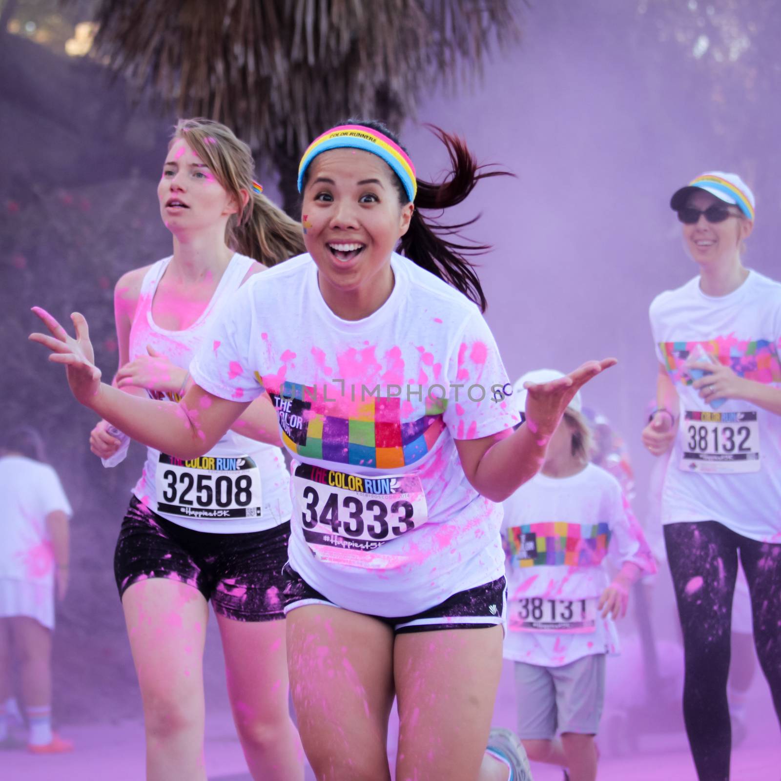 Ventura, CA - OCTOBER 18 : Participants coming through the pink color station at The Color Run 2014 in Ventura. OCTOBER 18, 2014 in Ventura, CA.