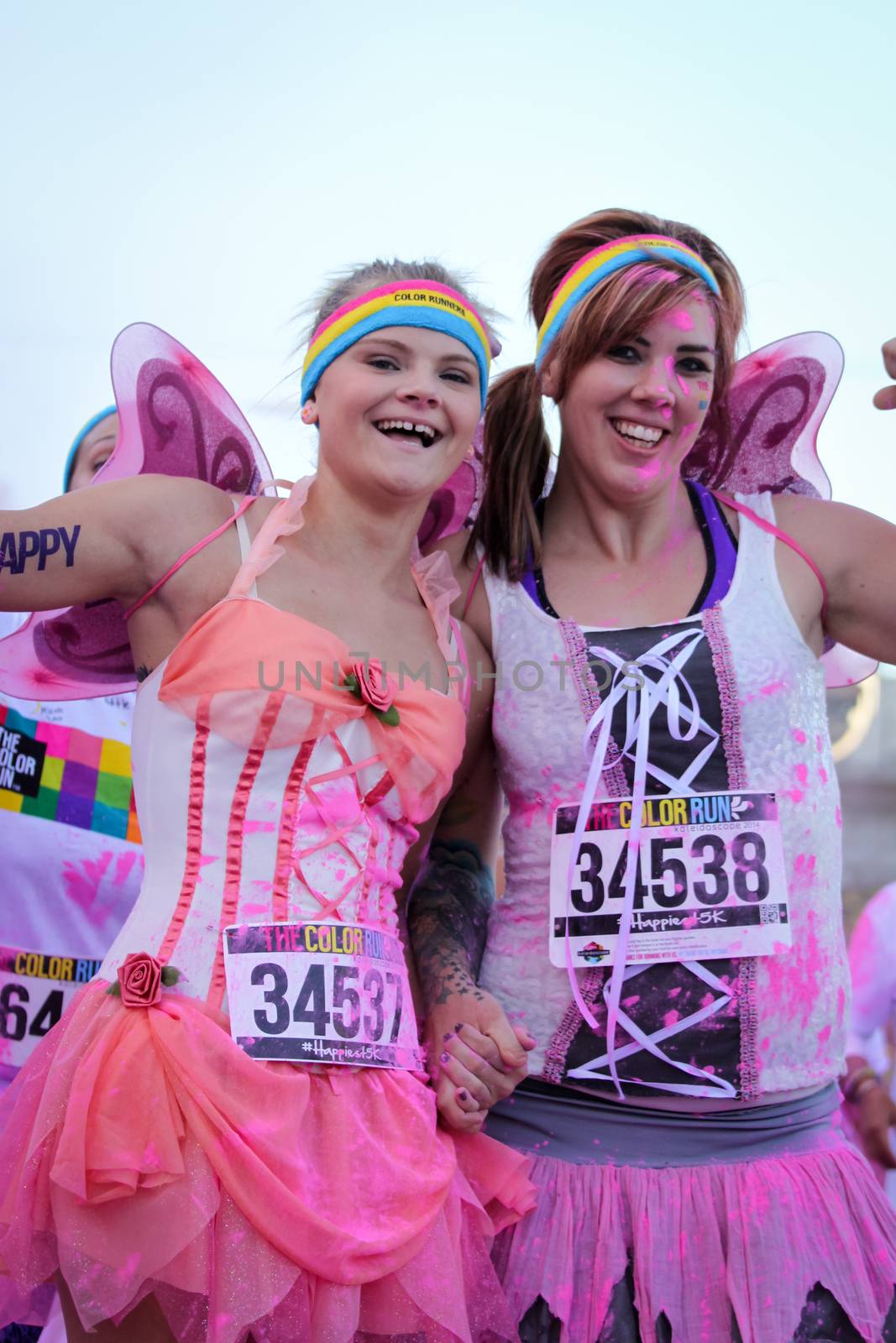 Ventura, CA - OCTOBER 18 : Participants coming through the pink color station at The Color Run 2014 in Ventura. OCTOBER 18, 2014 in Ventura, CA.