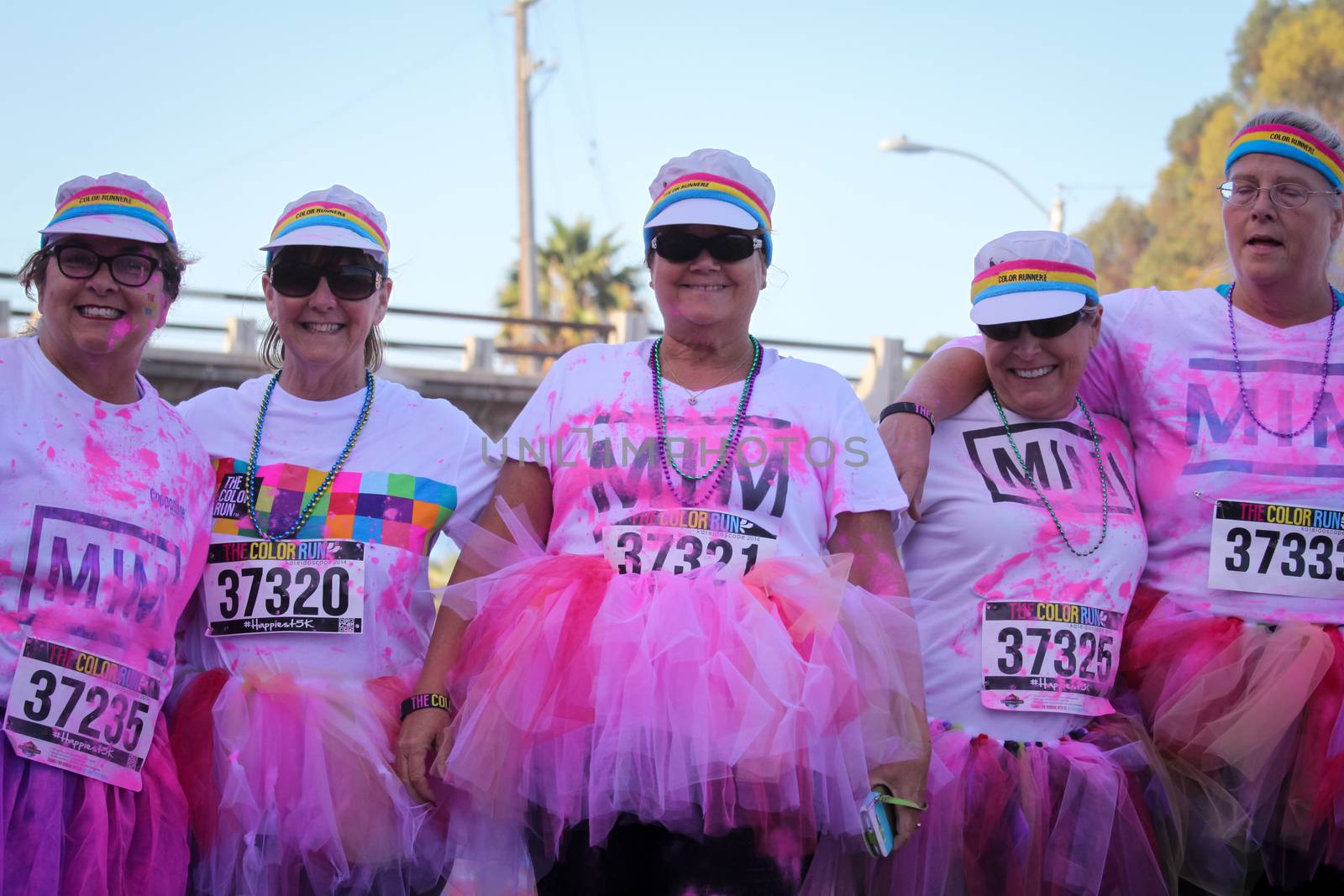 Ventura, CA - OCTOBER 18 : Participants coming through the pink color station at The Color Run 2014 in Ventura. OCTOBER 18, 2014 in Ventura, CA.