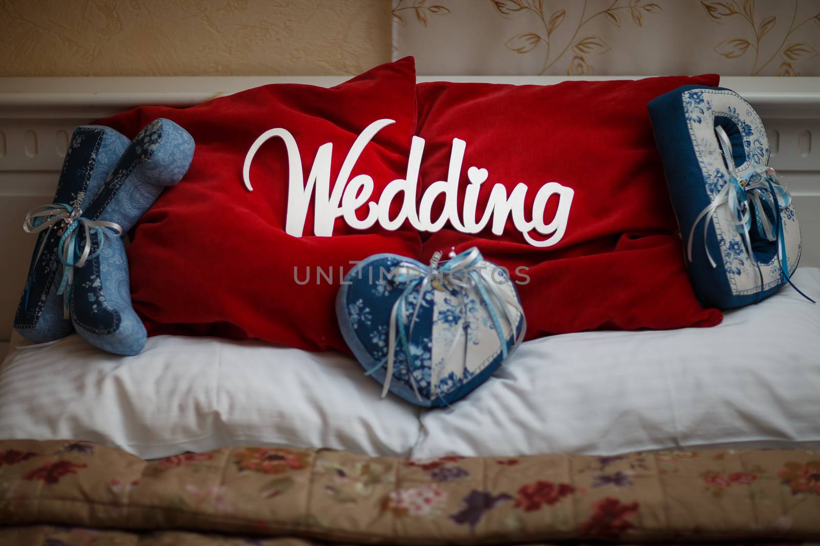 word white wedding on the beautiful red pillow