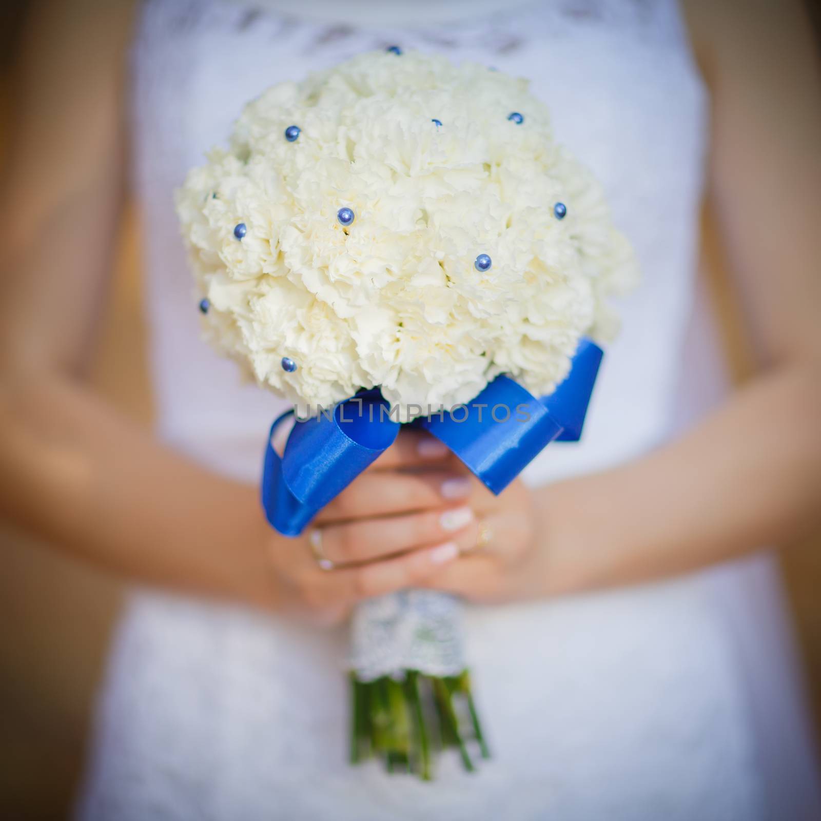 Wedding bouquet in hands of the bride