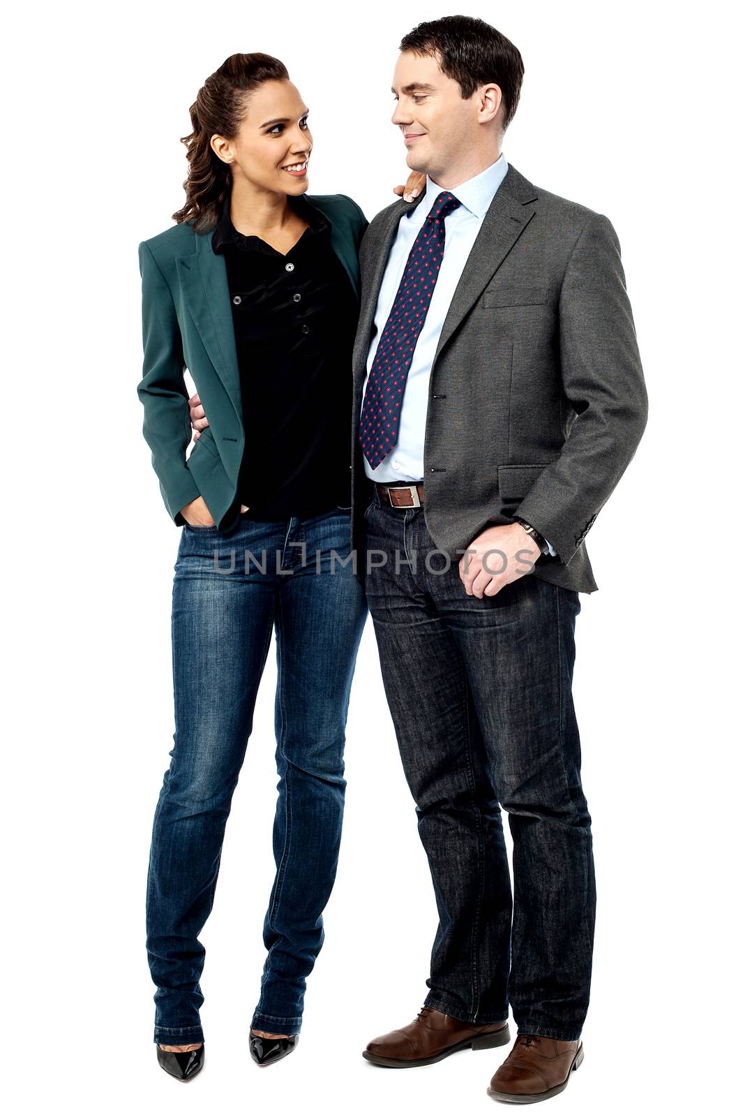 Businessman and woman talking together by stockyimages
