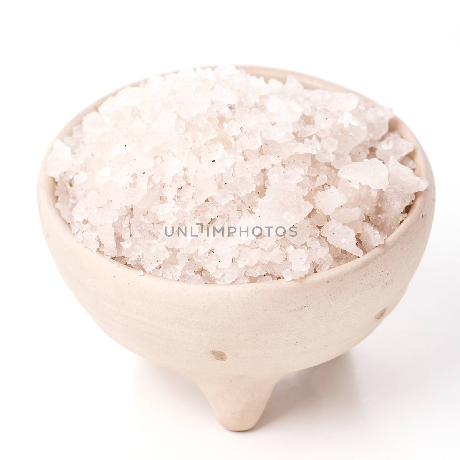 Heap of sea salt on a white background
