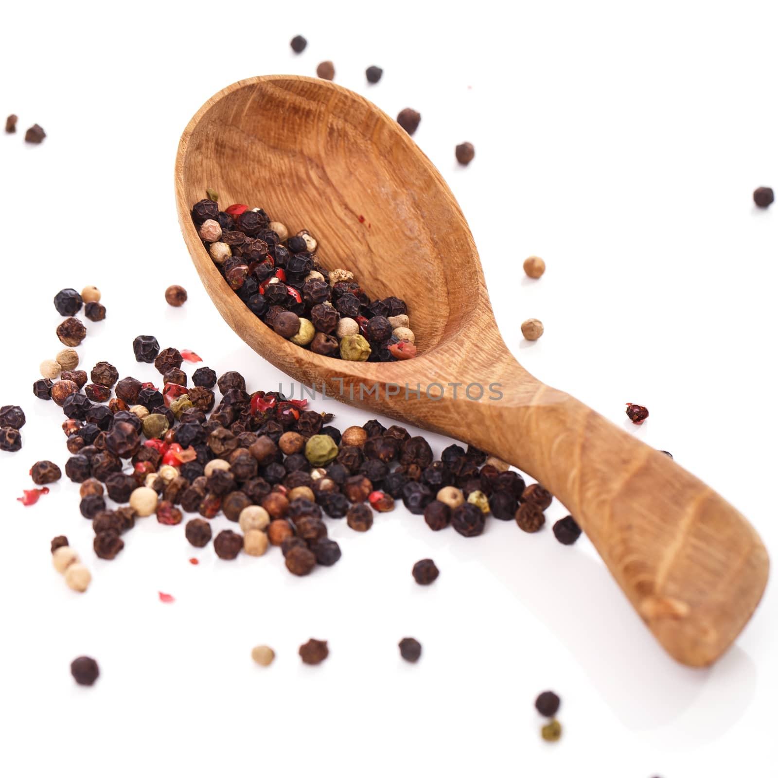 Peppercorn with a spoon on a white background