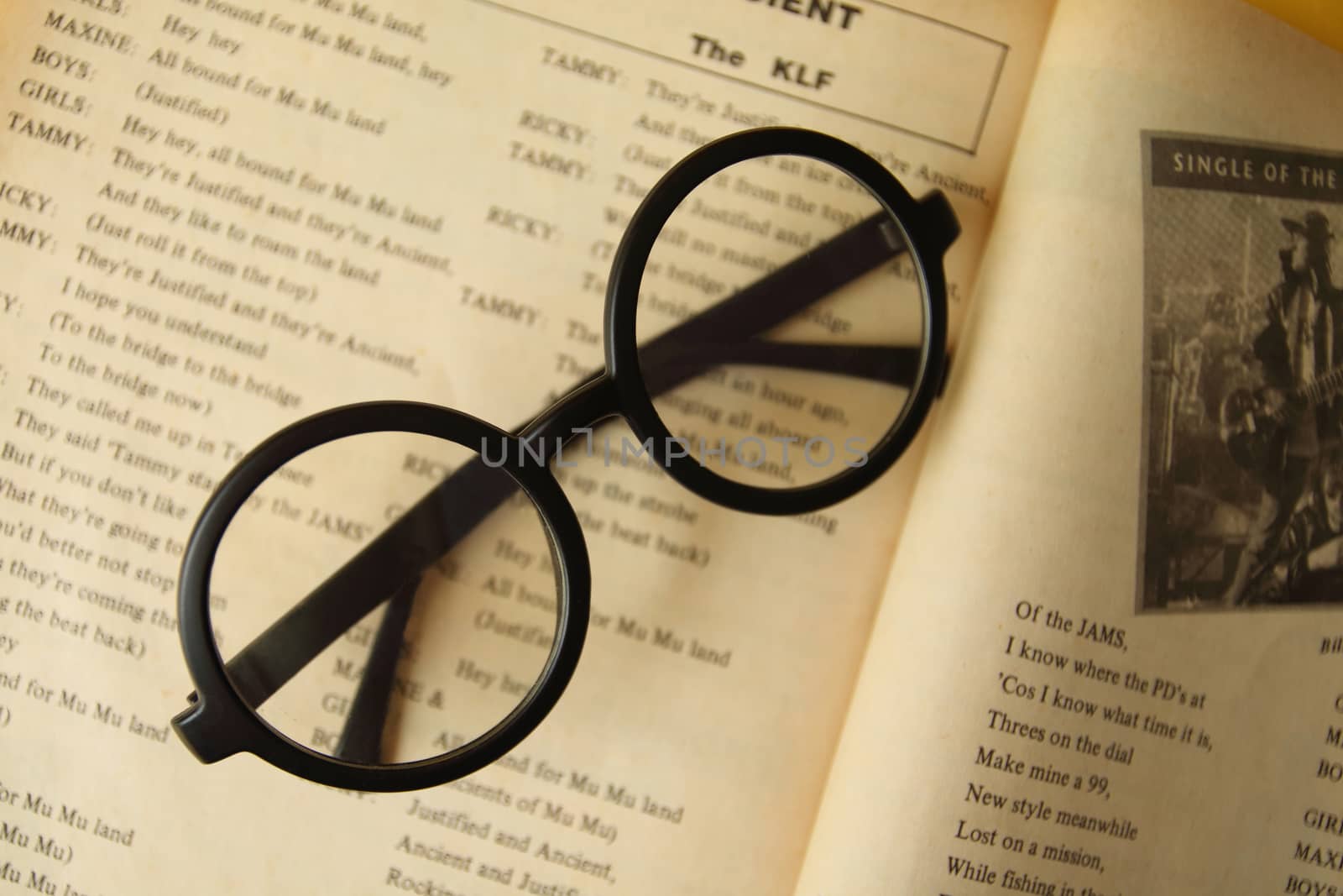 eyeglasses on the open book. by kaidevil
