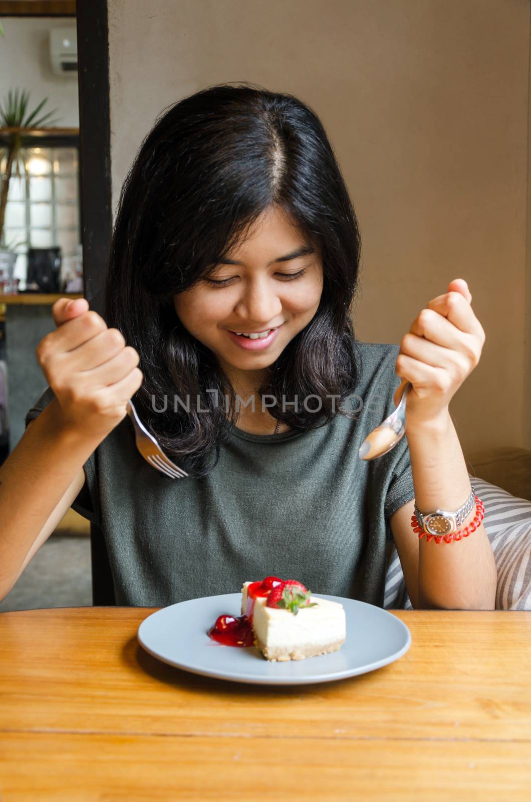 Young asian woman prepare to eating a cake in cafe
