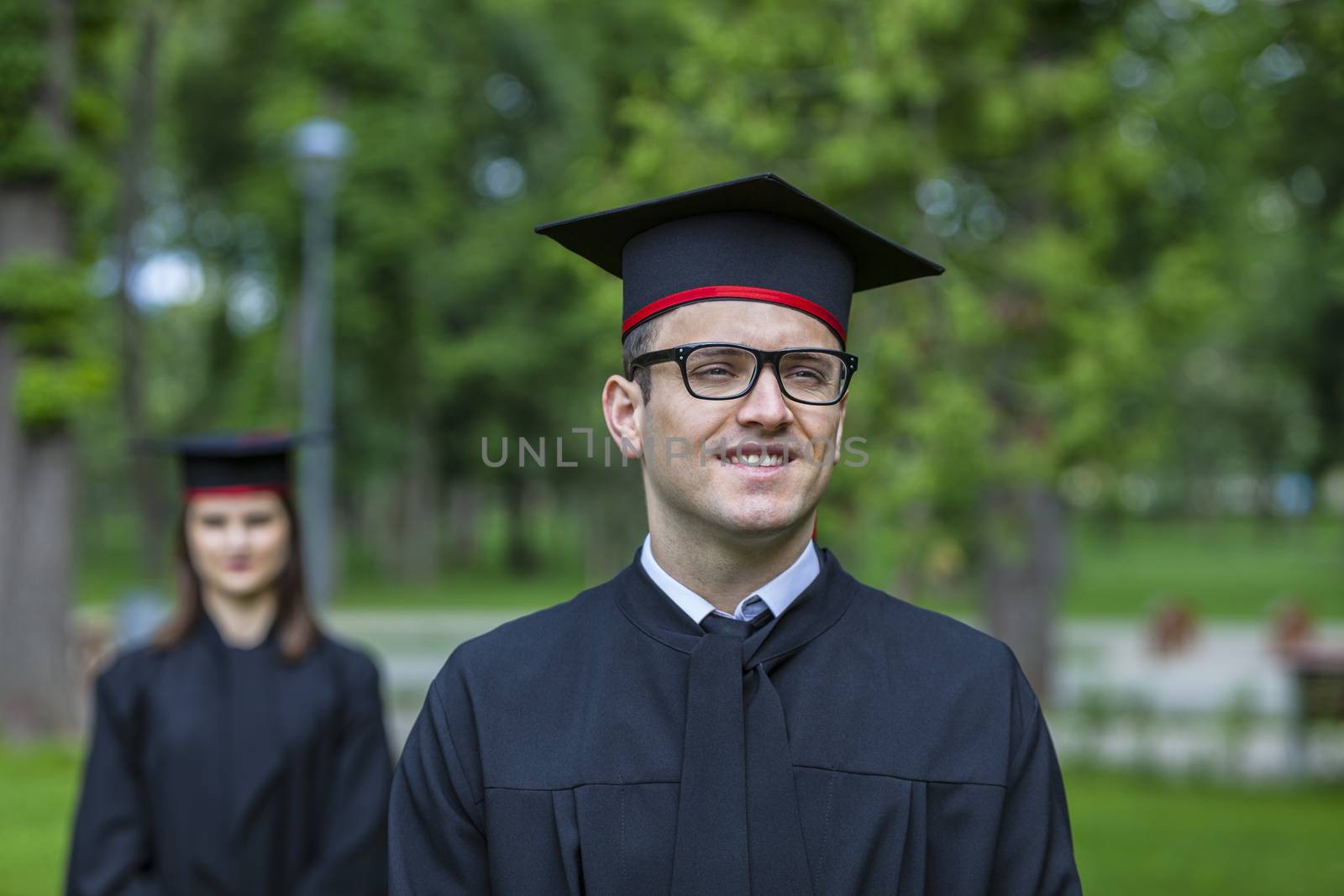 Outdoor portrait of a young student man in the graduation day.
