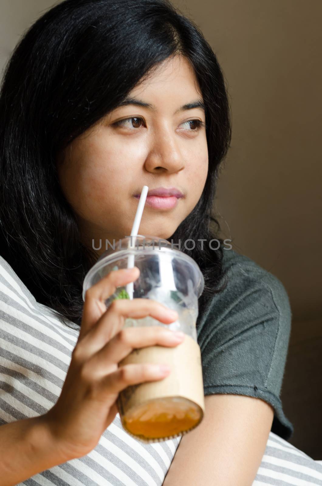 Relaxed woman drinking coffee at cafeteria