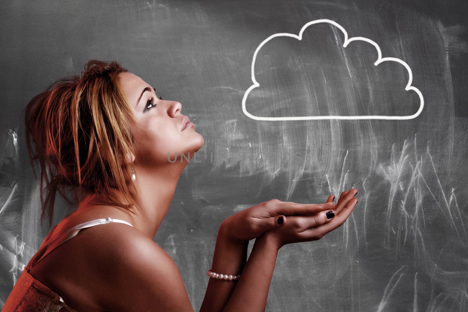 Cloud computing concept. Girl looking a cloud drawing on blackboard