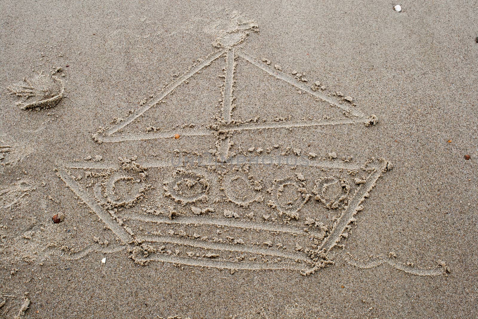 drawing a boat in the sand on beach