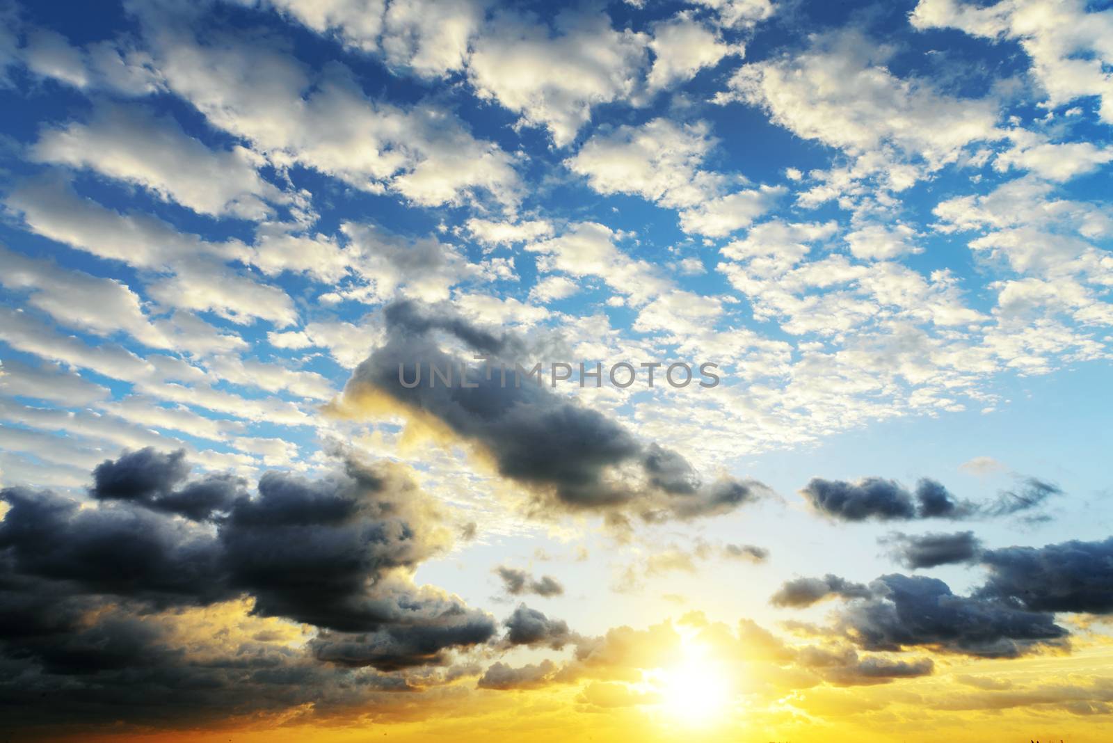 Sunrise with sun rays and clouds