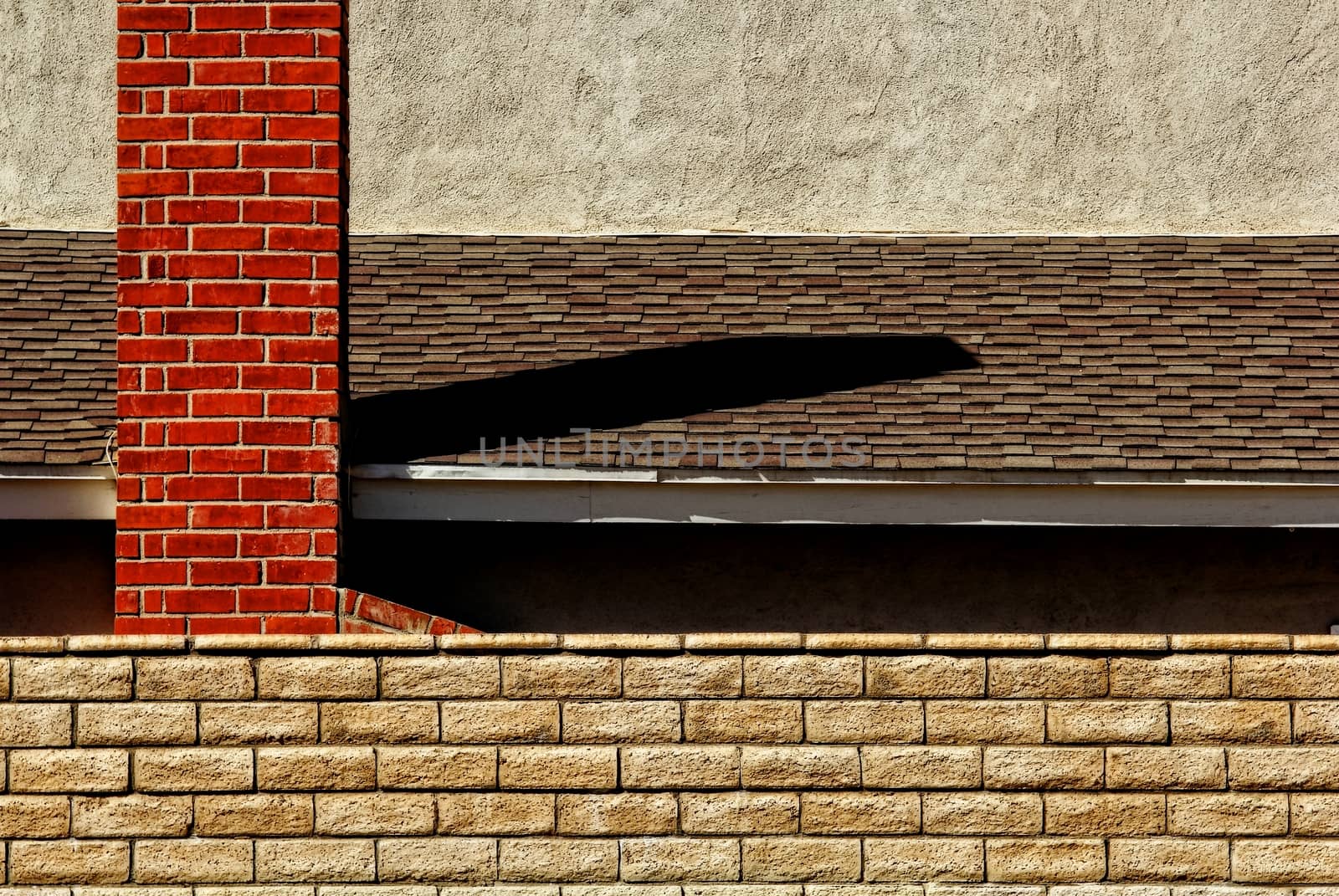 Brick chimney with roof and brick wall.
