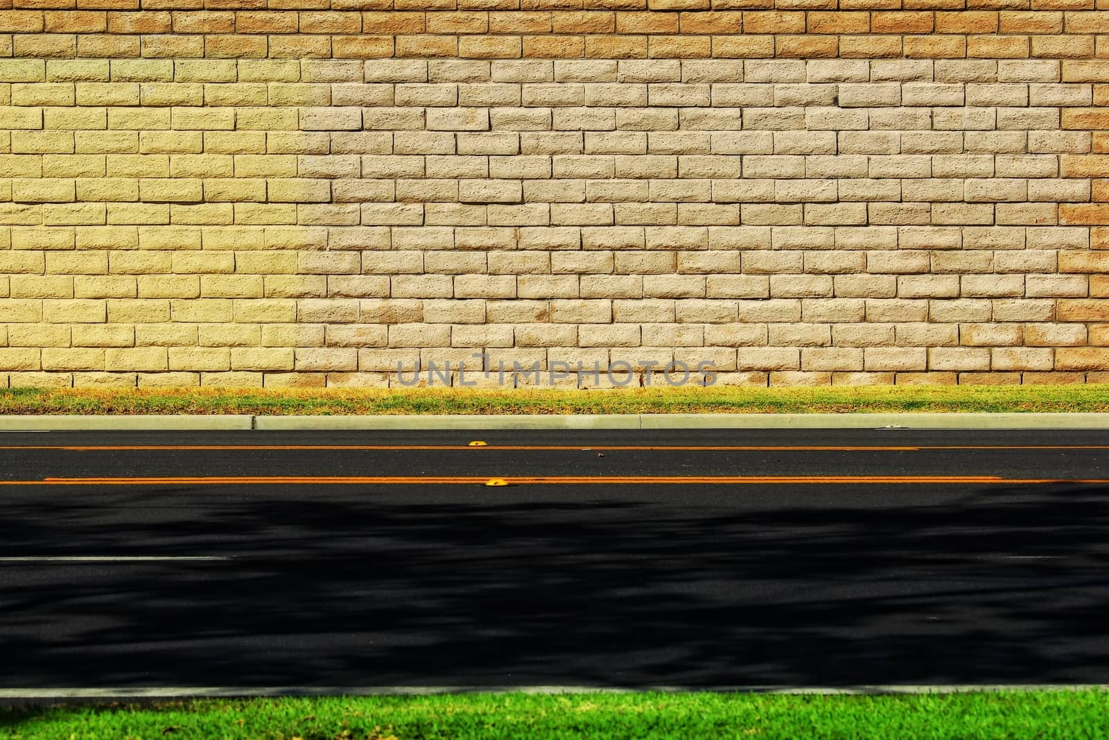 Empty road with brick wall background by Timmi