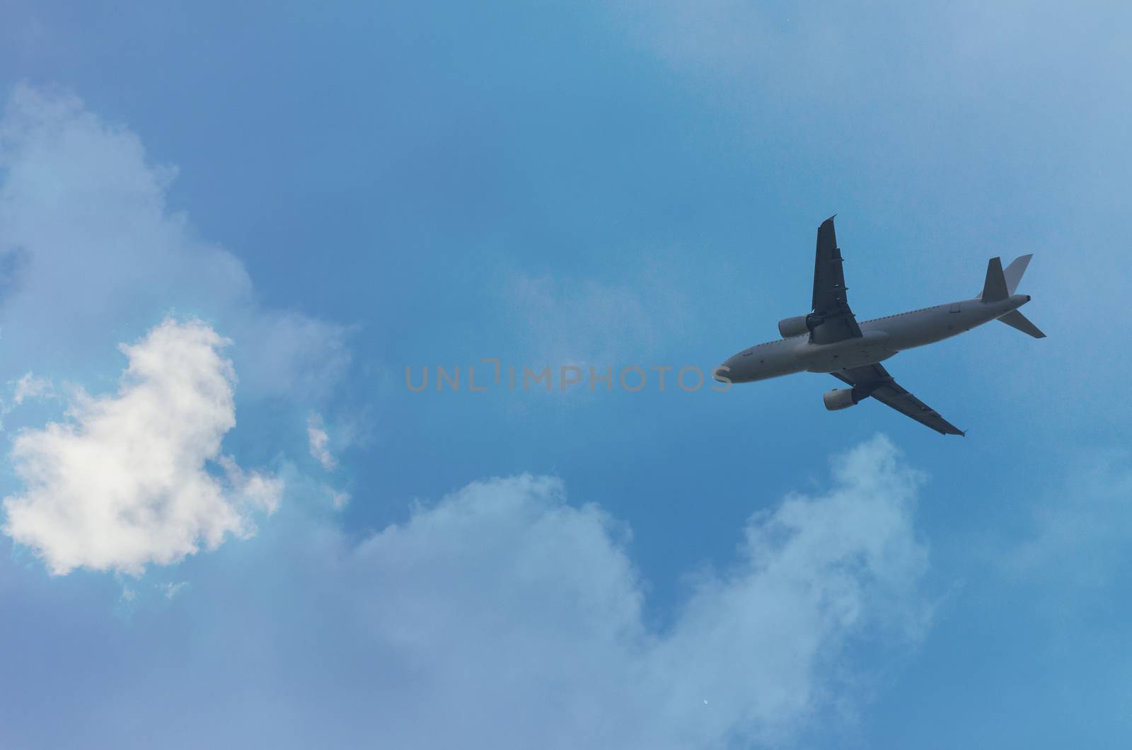 Airplane landing at sunset, panoramic frame