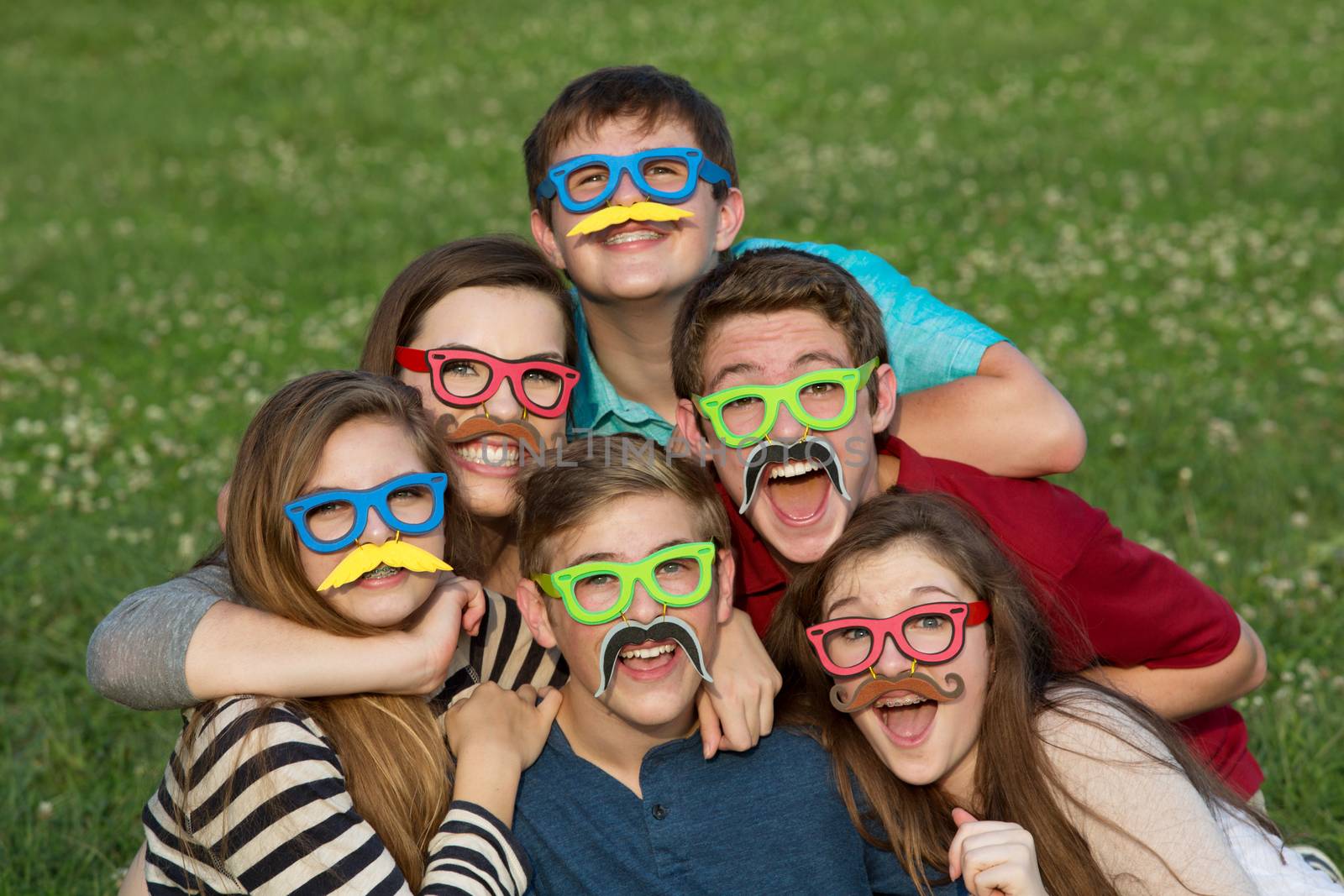 Five teenage male and females in mustache disguise