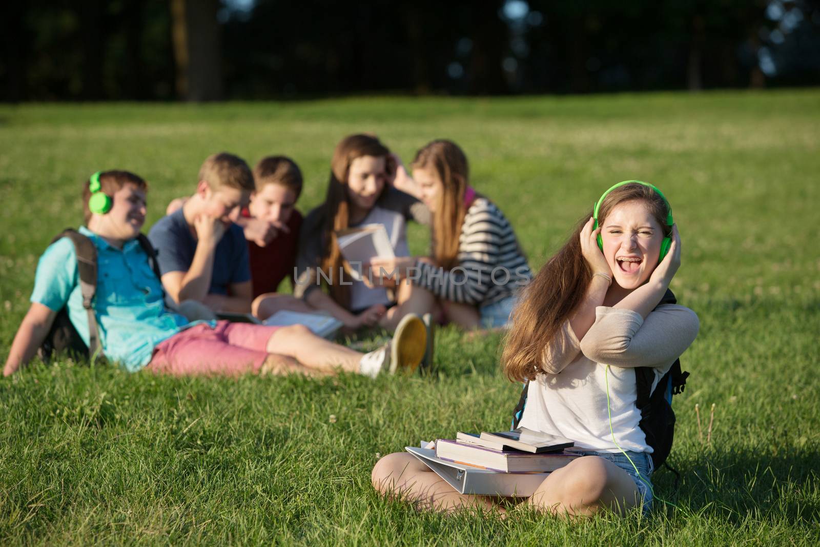 Cute singing female student with group outdoors