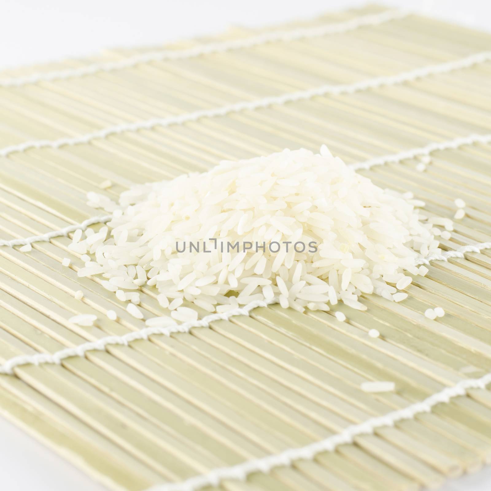 uncooked rice on wooden pad
