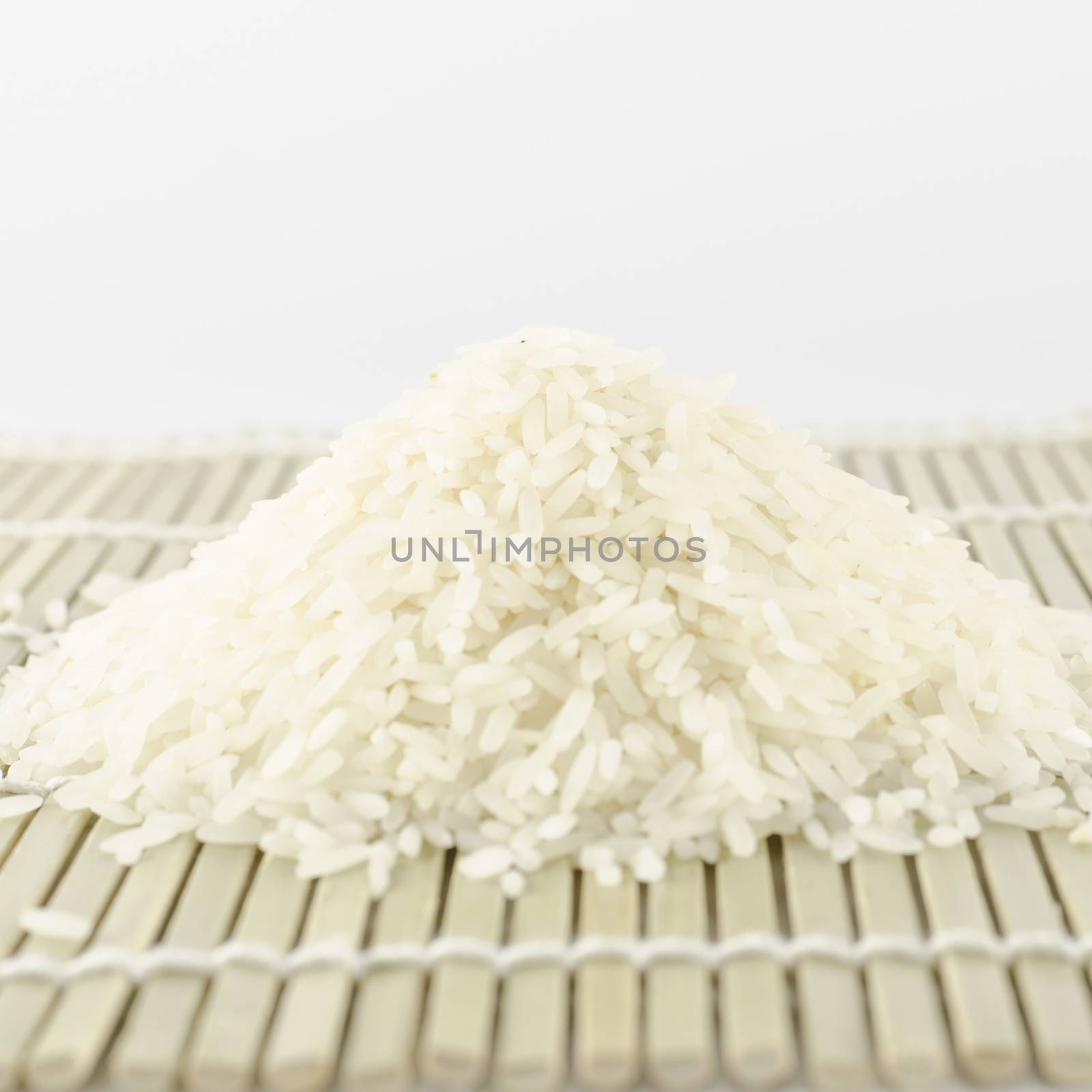 uncooked rice on wooden pad