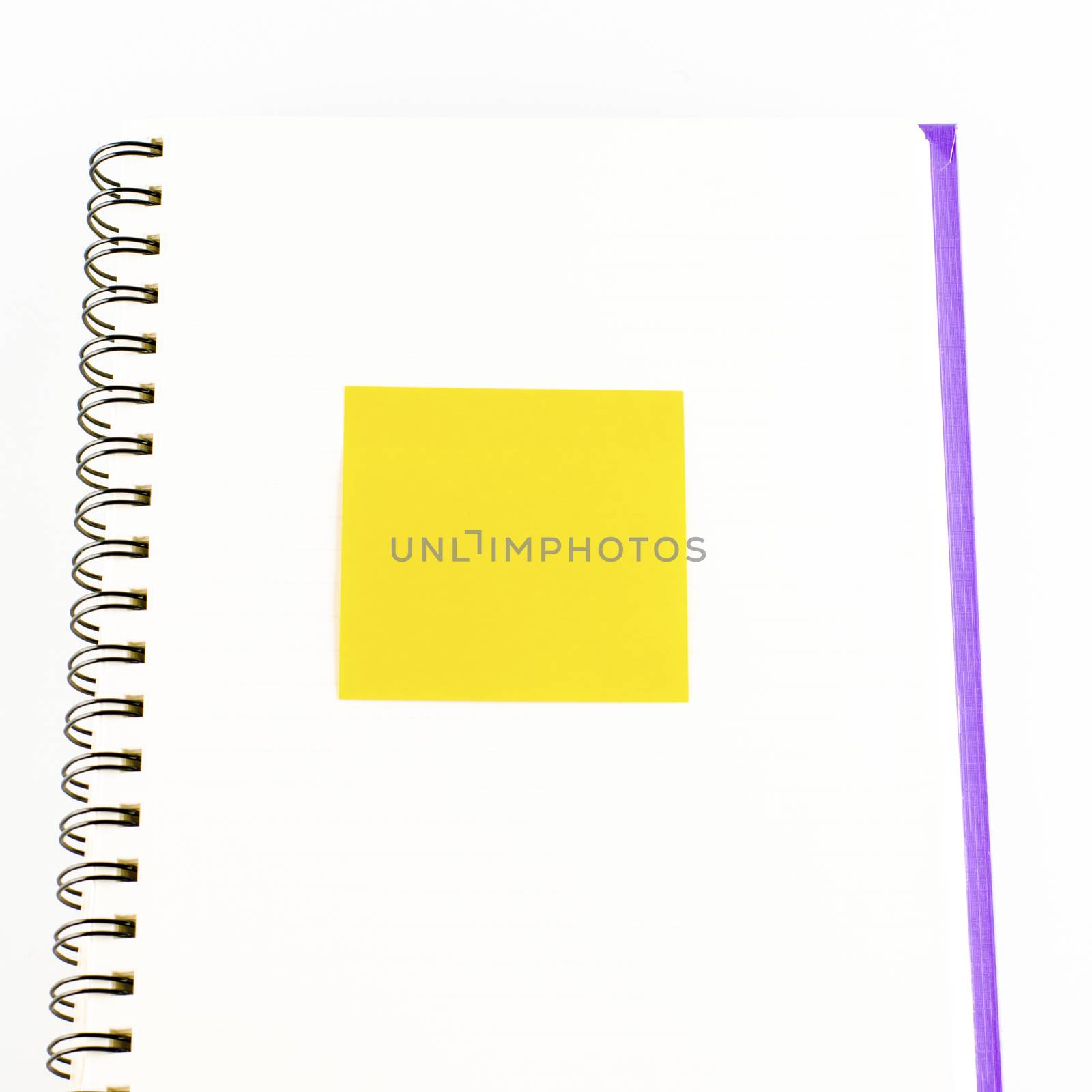 orange sticker note on notebook on a white background