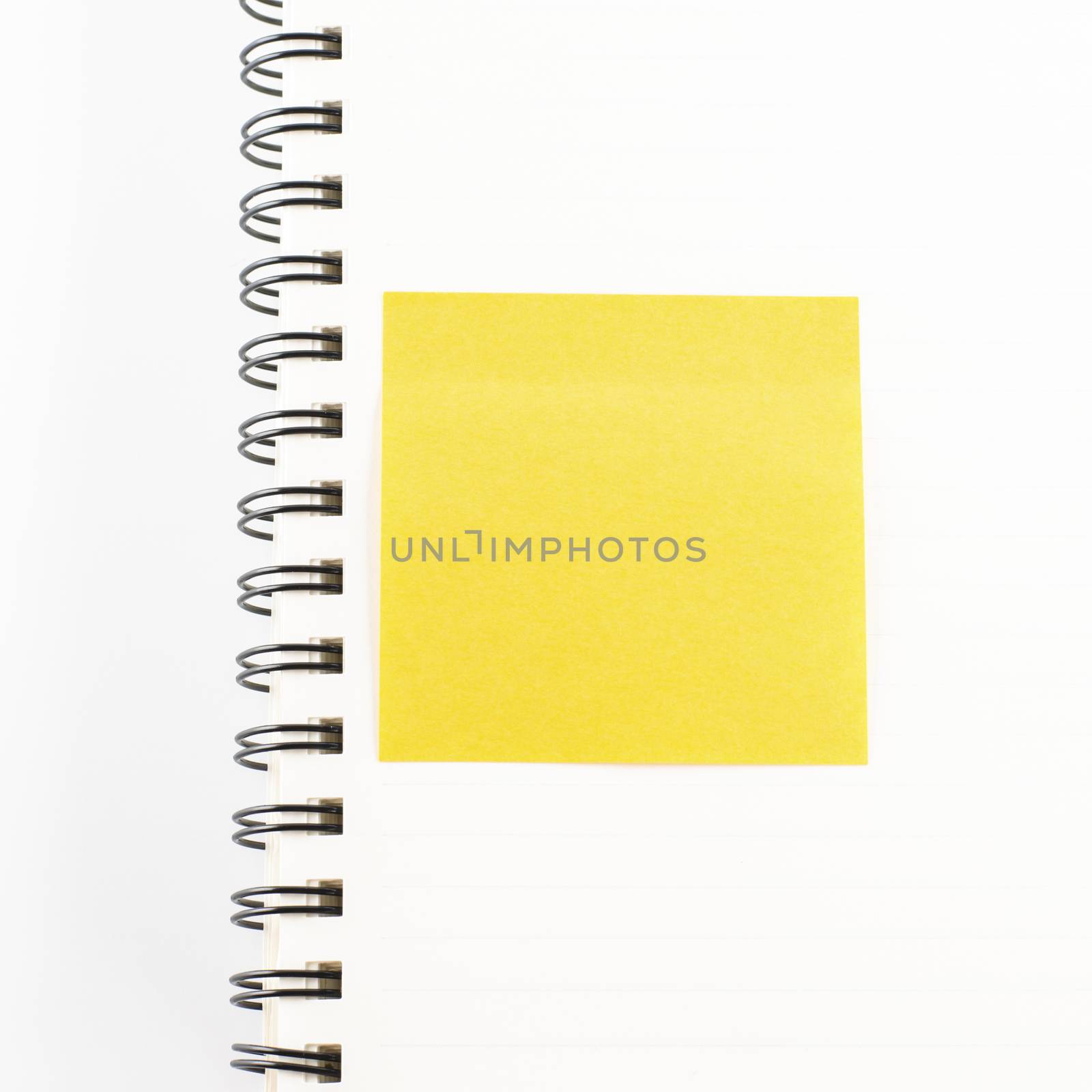 orange sticker note on notebook on a white background