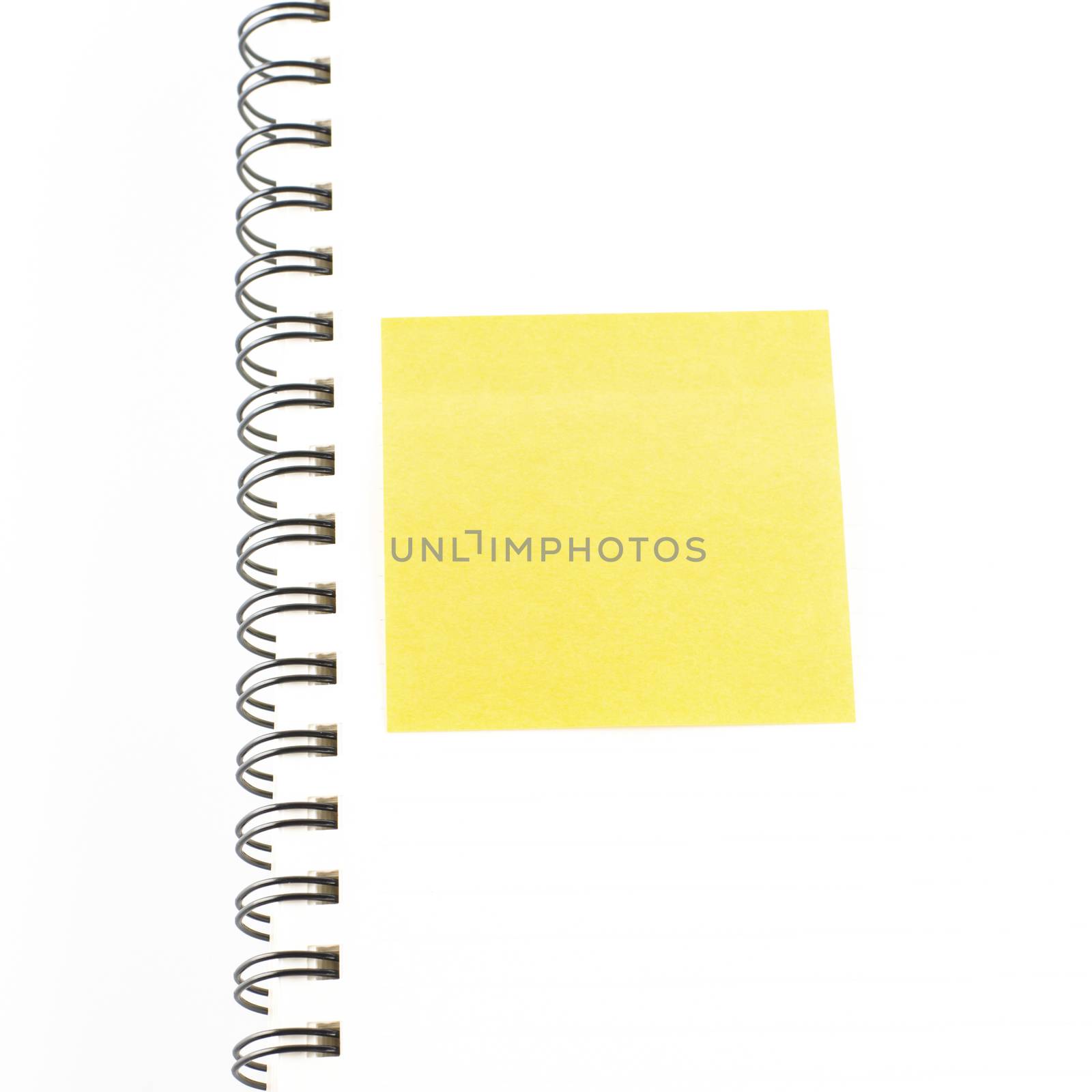 orange sticker note on notebook on a white background